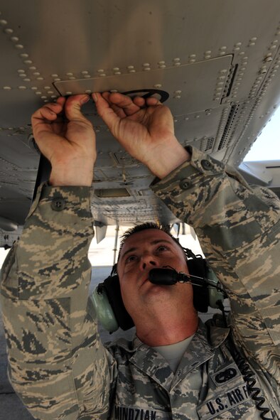 MOODY AIR FORCE BASE, Ga. -- Senior Airman Michael Mindziak, 476th Aircraft Maintenance Squadron crew chief, latches a panel under an A-10C Thunderbolt II aircraft before takeoff Feb. 23. The 476th Fighter Group was activated in 2009 as Moody's first step in total force integration. (U.S. Air Force photo/Airman 1st Class Benjamin Wiseman)(RELEASED)