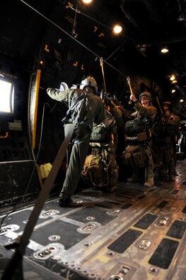 VALDOSTA, Ga. -- A loadmaster from the 71st Rescue Squadron ensures all jumpers are attached to the static line before opening the paratroop doors Feb. 24. The loadmaster was responsible for coordinating with the jump leader to ensure that all personnel exited the aircraft safely. (U.S. Air Force photo/Airman 1st Class Benjamin Wiseman)(RELEASED)
