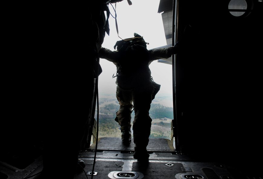 VALDOSTA, Ga. -- A member of the 38th Rescue Squadron prepares to static line jump from the paratroop doors of an HC-130P Combat King aircraft from the 71st Rescue Squadron Feb. 24. A combined 12 members from the 347th Rescue Group and 820th Base Defense Group jumped from the aircraft. (U.S. Air Force photo/Airman 1st Class Benjamin Wiseman)(RELEASED)