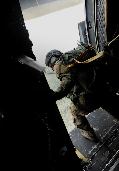 VALDOSTA, Ga. -- Staff Sgt. Paul Merck, 38th Rescue Squadron survival, evasion, resistance and escape specialist, checks for deployed parachutes after three jumpers exit the aircraft during a static line jump Feb. 24. Sergeant Merck was responsible for getting all the jumpers out and over the safe drop zone. (U.S. Air Force photo/Airman 1st Class Benjamin Wiseman)(RELEASED)