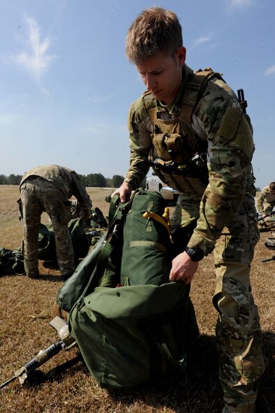 VALDOSTA, Ga. -- Senior Airman Dustin Gorski, 38th Rescue Squadron pararescueman, removes his packed parachute from his bag before a static line jump Feb. 24. The Valdosta Regional Airport shut down for three hours so members from Moody could have a safe drop zone. (U.S. Air Force photo/Airman 1st Class Benjamin Wiseman)(RELEASED)