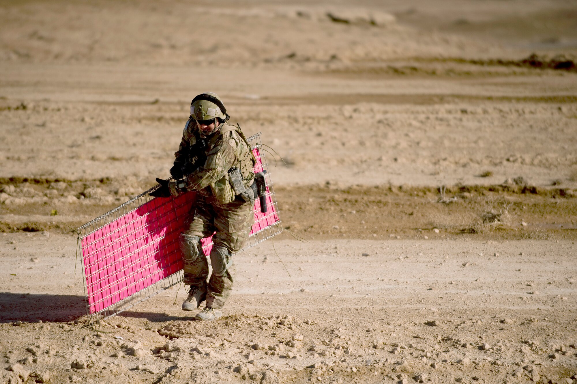 Tech. Sgt. Jason Rutledge tears down airfield panels on a dirt landing zone Feb. 16, 2011, at Forward Operating Base Lagman, Afghanistan. The panels were set up to show a C-130 Hercules aircrew where they should land. Sergeant Rutledge was there to make sure the dirt landing zone was safe for aircraft to land. Sergeant Rutledge is a joint terminal attack controller assigned to the 807th Expeditionary Air Support Operations Squadron. (U.S. Air Force photo/Master Sgt. Adrian Cadiz)