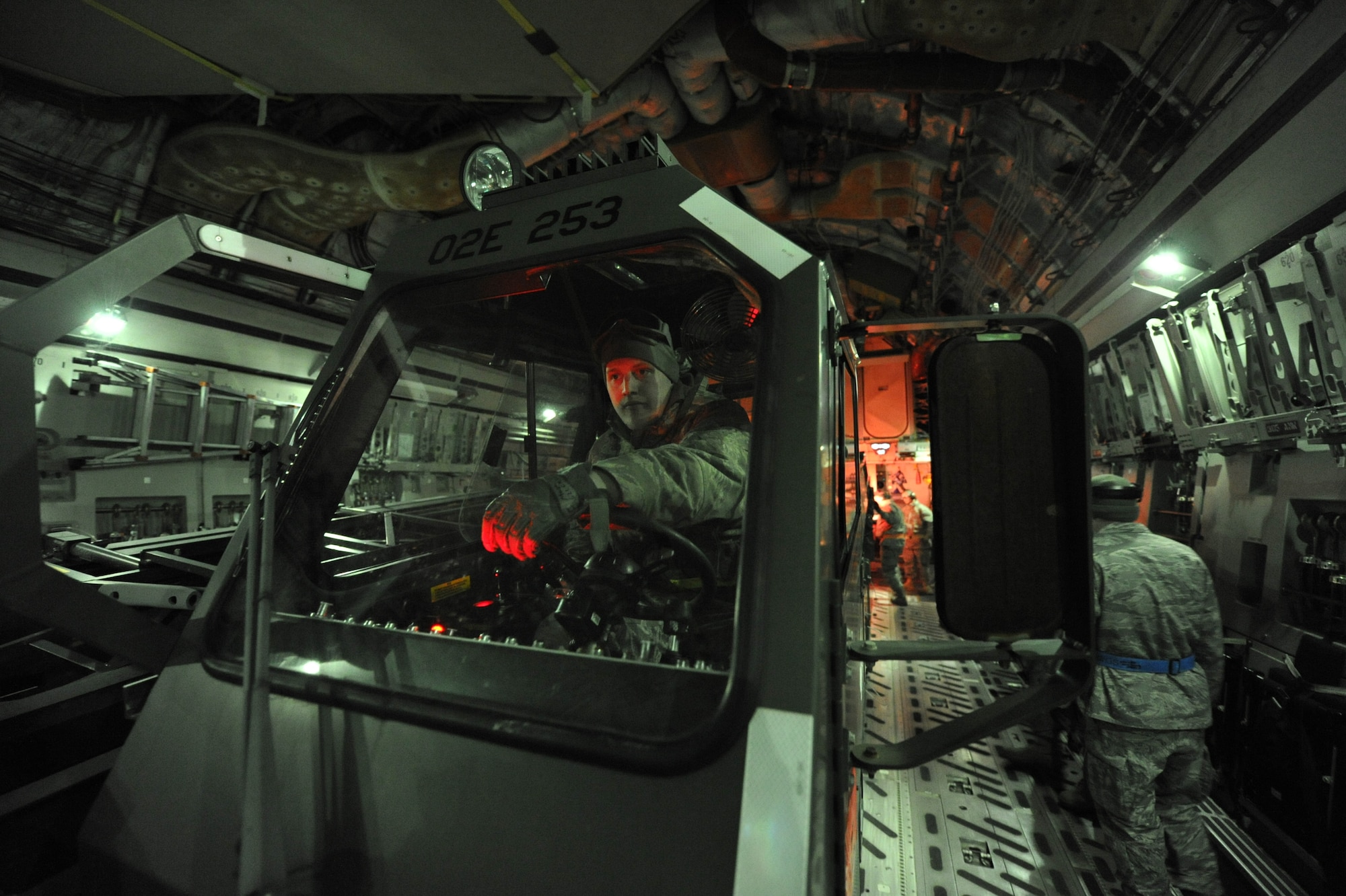 JOINT BASE MCGUIRE-DIX-LAKEHURST, N.J. – Airman 1st Class Casanova Geary, 819th Global Support Squadron aerial port apprentice, waits for clearance to drive a next-generation small loader off of a C-17 Globemaster II during a nighttime engine-running offload at Lakehurst Naval Air Engineering Station Feb. 23.  Sergeant Geary is a member of the 621st Contingency Response Wing and was participating in a field training exercise that simulated the unit’s ability to rapidly deploy to remote locations and provide critical airlift support. (U.S. Air Force photo/Tech. Sgt. Parker Gyokeres/released)