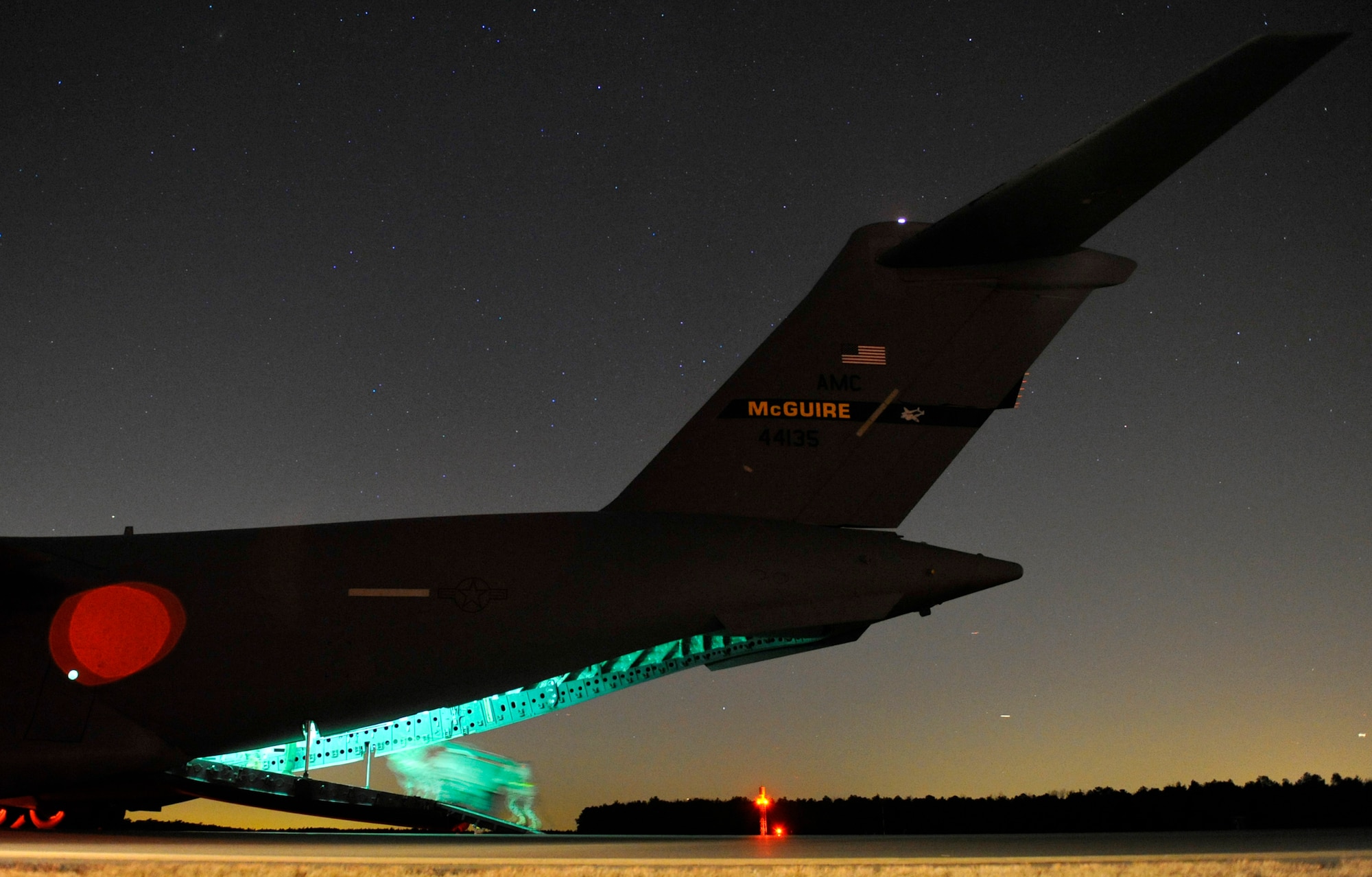 JOINT BASE MCGUIRE-DIX-LAKEHURST, N.J. – Aerial porters from the 621st Contingency Response Wing roll a lighting cart from a C-17 Globemaster II during an engine-running offload at Lakehurst Naval Air Engineering Station Feb. 23. The Airmen were participating in a field training exercise to hone the wing’s ability to deploy worldwide to austere locations and provide mobility airlift support.  (U.S. Air Force photo/Tech. Sgt. Parker Gyokeres/released)