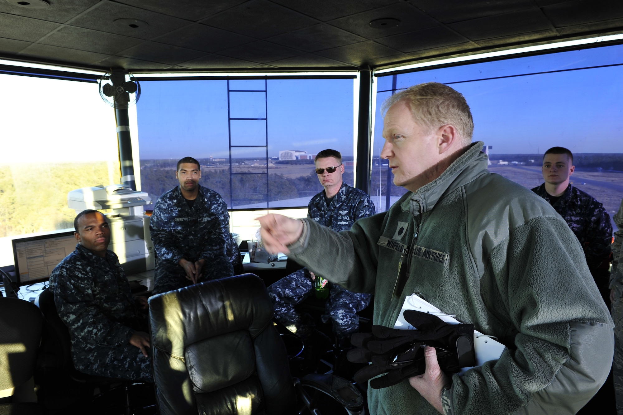 JOINT BASE MCGUIRE-DIX-LAKEHURST, N.J. – Lt. Col Emmet Wingfield, 621st Contingency Response Element commander, discusses the airfield movements of his team of mobility Airmen with aircraft control tower staff at Lakehurst Naval Air Engineering Station Feb. 23.  One of the first roles of a CRE leader after arriving at a new location is to coordinate the actions of his team with host base authorities to minimize misunderstandings, delays and any possible safety issues. (U.S. Air Force photo/Tech. Sgt. Parker Gyokeres/released)