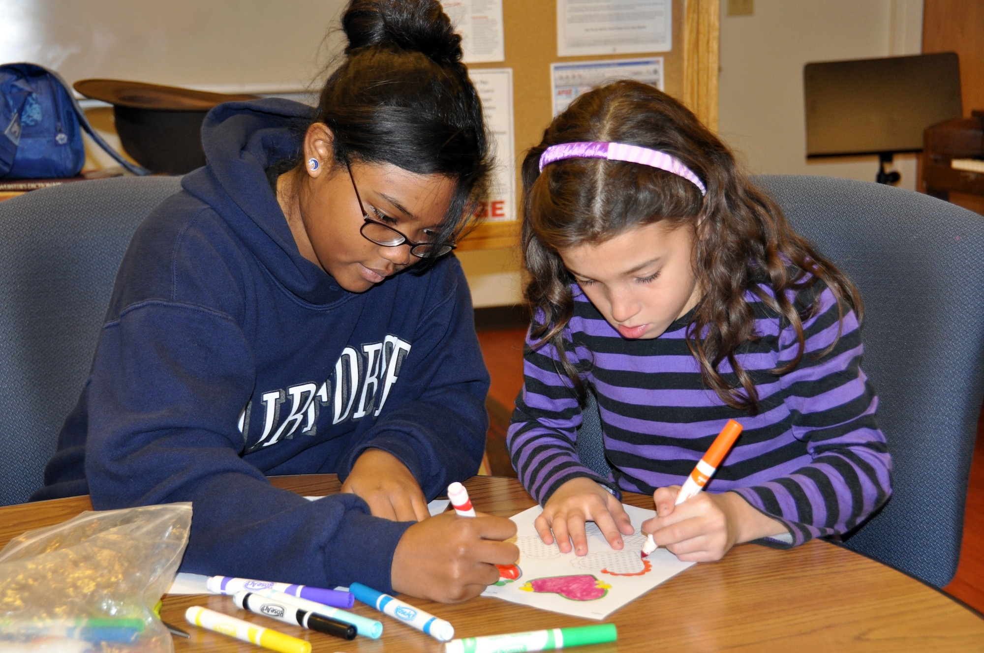 Kiara, Big Brothers Big Sisters mentor, and Nalla, BBBS mentee, participate in arts and crafts Feb. 18 during the weekly Youth 4 Youth program at the Travis Youth Center.