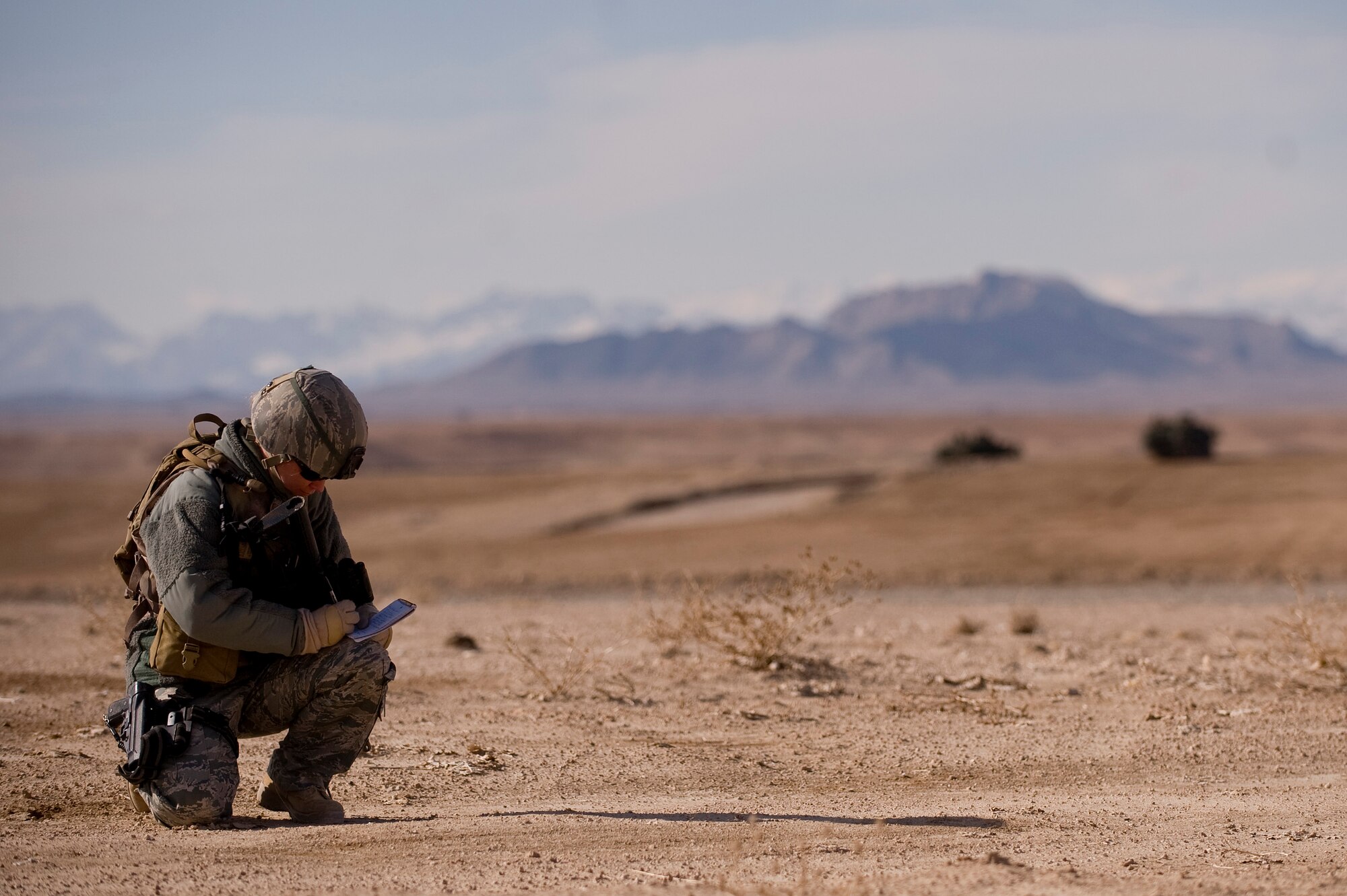 Tech. Sgt. Stacia Zachary, U.S. Air Forces Central Combat Camera combat correspondent, takes notes as she covers Joint Terminal Air Control airmen from the 807th Air Support Operations Squadron, Forward Operating Base Lagman. The NCO is deployed from Team Eglin Public Affairs, Eglin Air Force Base, Fla. Sergeant Zachary, an award-winning PA journalist, was selected to serve with Combat Camera personnel who deploy to the most austere environments at a moment's notice to capture still and motion imagery of military operations. The Airmen she is covering in this picture were making sure a dirt landing zone in the Zabul province of Afghanistan was safe for a cargo carrying C-130 Hercules to land and provided the aircrew with any pertinent information via radio communications. The aircrew was delivering needed cargo for one of the nearby military outposts. (U.S. Air Force photo/Master Sgt. Adrian Cadiz)