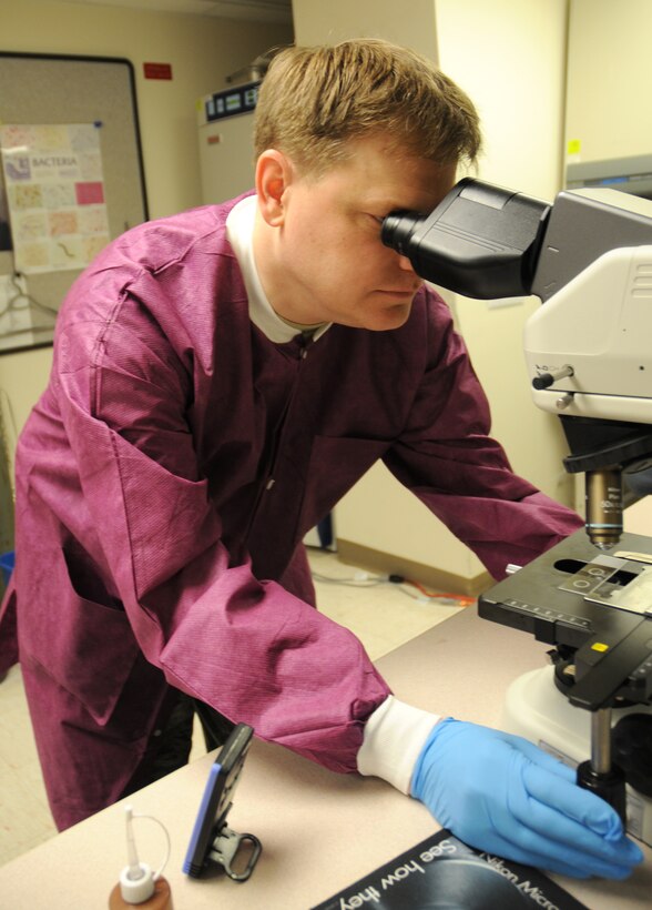 Master Sgt. Eric Sellers, 512th Aerospace Medicine Squadron laboratory services NCO in charge, examines a microbiotic samples under the microscope. As a laboratory technician, Sergeant Sellers tests and analyzes specimens using scientific laboratory techniques to aid in the diagnosis, treatment and prevention of diseases. The sergeant is an avid comic book fan and assisted in the production of a magazine that highlights the work of comic illustrator George Perez. All proceeds benefit the Wounded Warror Project. (U.S. Air Force photo/Capt. Marnee A.C. Losurdo)