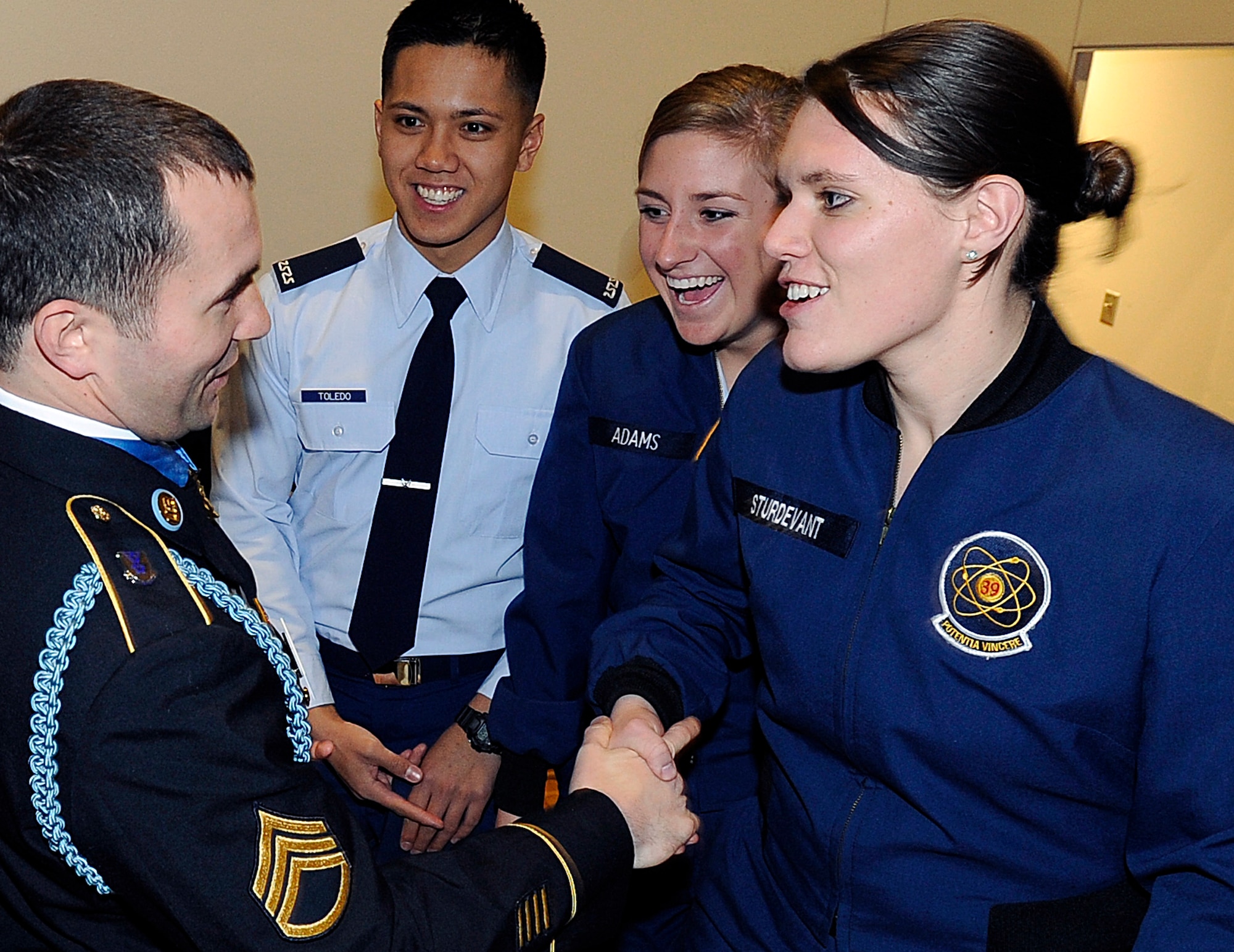 Army Staff Sgt. Salvatore Giunta talks with Cadet 1st Class Laura Sturdevant, right, after his keynote speech at the Air Force Academy's National Character and Leadership Symposium Feb. 24, 2011. Sergeant Giunta, the first living servicemember to receive the Medal of Honor since the Vietnam War, received the medal for heroic actions in Afghanistan Oct. 25, 2007. Cadet Sturdevant is assigned to Cadet Squadron 39; also pictured are Cadets 4th Class Reynaldo Toledo and Jessica Adams of CS 19. (U.S. Air Force photo/Mike Kaplan)