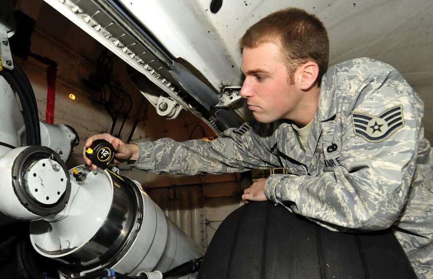 Staff Sgt. Christopher Evans, 62nd Maintenance Squadron crew chief, measures a piece of equipment on the landing gear of a C-17 Globemaster III Feb. 24, 2011, at Joint Base Lewis-McChord, Wash. (U.S. Air Force photo/Airman 1st Class Leah Young)