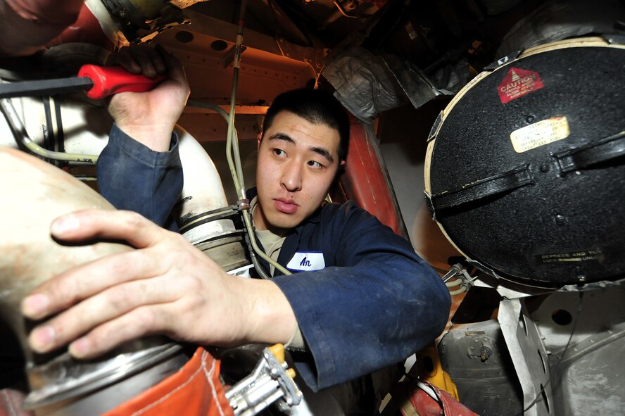 Airman Horew An, 62nd Maintenance Squadron electrical and environmental technician, repairs the air conditioning system of a C-17 Globemaster III as part of a routine maintenance inspection Feb. 24 at Joint Base Lewis-McChord, Wash. (U.S. Air Force photo/Airman 1st Class Leah Young)
