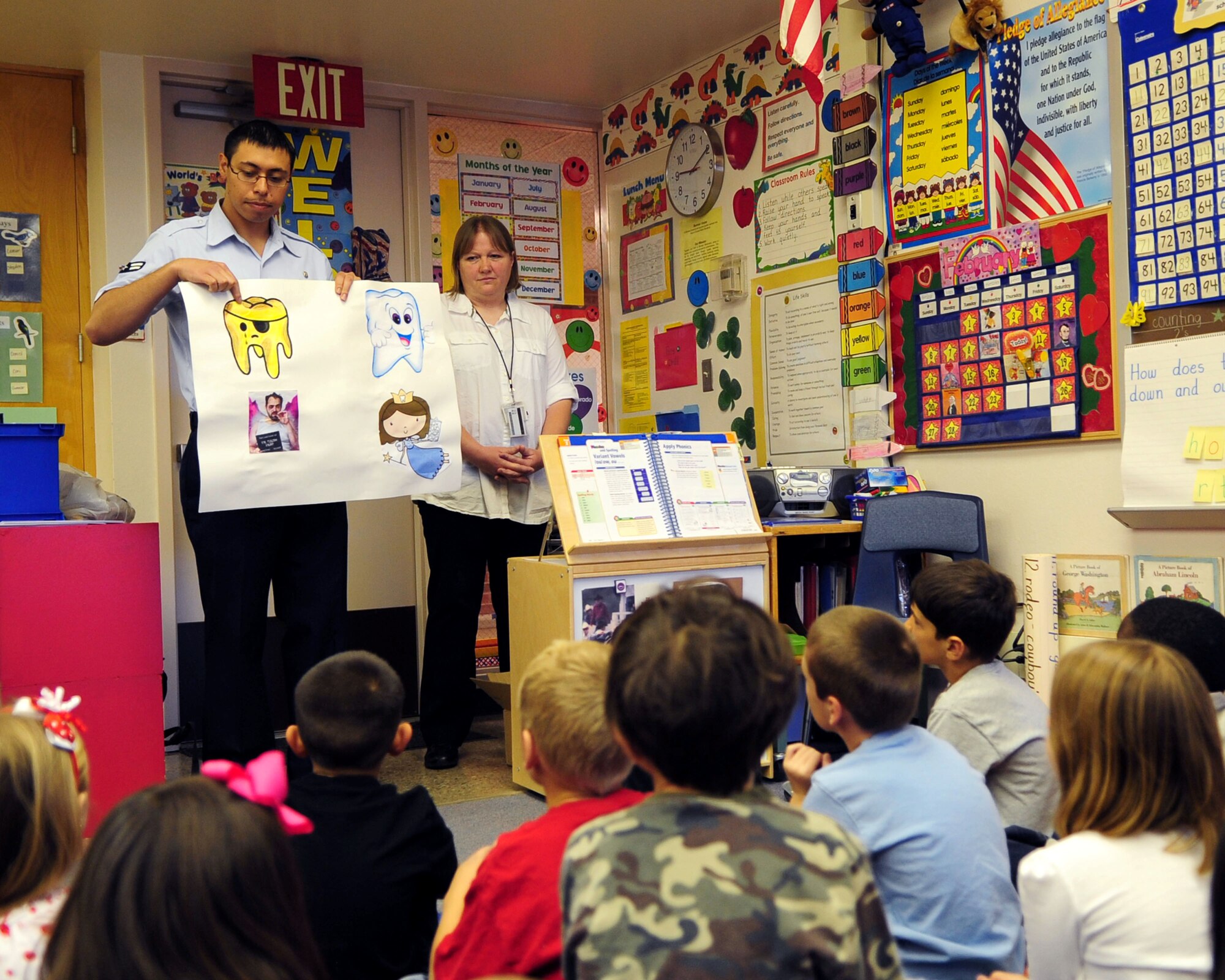 DAVIS-MONTHAN AIR FORCE BASE, Ariz. - Senior Airman Christopher Young, 355th Dental Squadron dental assistant, talks about good and bad food choices as part of National Children’s Dental Health month event here Feb. 18. Airmen from the 355th DS visited the school to educate the children on good oral hygiene. (U.S. Air Force photo/Airman 1st Class Jerilyn Quintanilla)