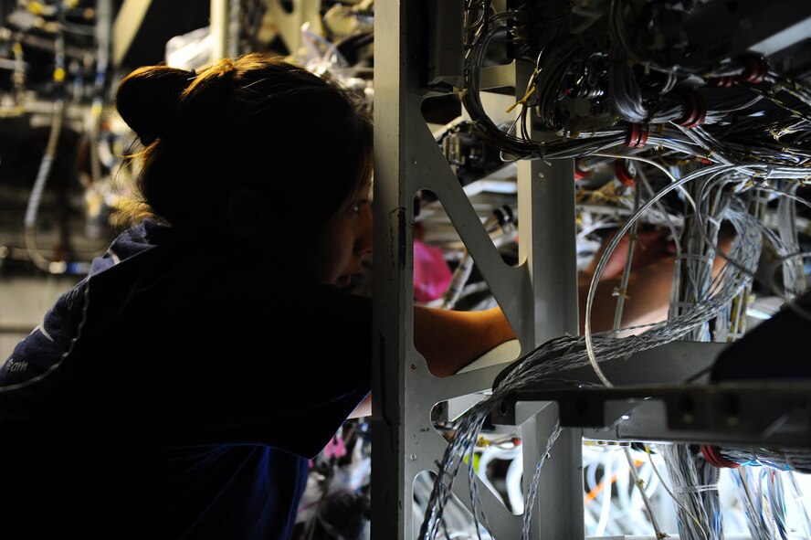 DYESS AIR FORCE BASE, Texas — Lori Adams, Boeing Company employee, works on the inside of a B-1 Bomber Feb. 24 located at building 5020 here. The sniper advanced targeting pod is a long-range precision targeting system that supports the precision strike mission by providing positive target identification, autonomous tracking, coordinate generation and precise weapons guidance from extended standoff ranges supporting air-to-ground operations. (U.S. Air Force photo/ Airman 1st Class Courtney Moses)