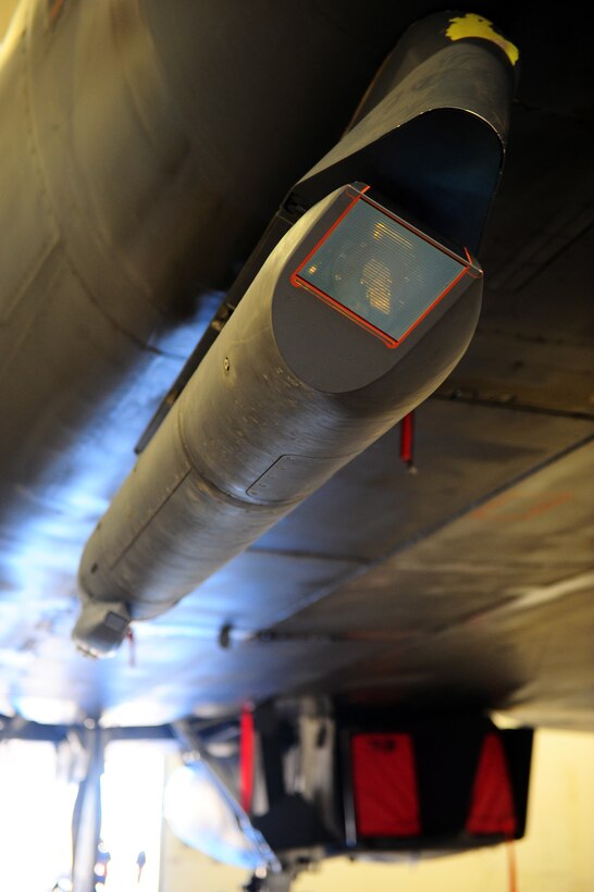DYESS AIR FORCE BASE, Texas — A sniper advanced targeting pod connects to the under carriage of a B-1 Bomber Feb. 24 in the Three Bay Hanger here. The sniper pod is a long-range precision targeting system that supports the precision strike mission by providing positive target identification, autonomous tracking, coordinate generation and precise weapons guidance from extended standoff ranges supporting air-to-ground operations. (U.S. Air Force photo/ Airman 1st Class Courtney Moses)