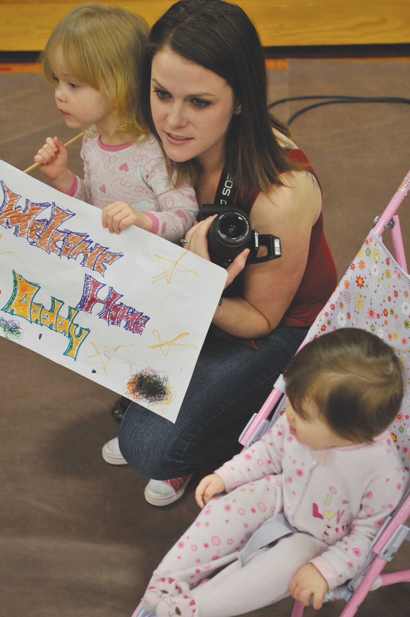 Michele Locklear and daughters, Katrina, and Ciara, eagerly anticipate the return home of Sgt. Edward Locklear of the 567th ICTC. This marks the third deployment for Sergeant Locklear. (Photo by Sgt. 1st Class Kelly Jo Bridgwater)

