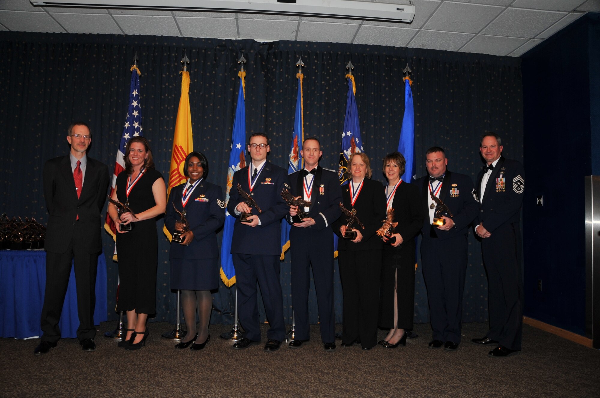 AFNWC staff annual award winners with Dr. Wayne Brasure, Air Force Nuclear Weapons Center Executive Director are Crystal Franco, AFNWC staff Civilian of the Year Category II,  Staff Sgt. Elisha Peters, AFNWC staff NCO of the Year,  A1C Eric Nagel, AFNWC staff Airman of the Year,  1st Lt. Bradley Diedrick, AFNWC staff Company Grade Officer of the Year,  Donna Heinz, AFNWC staff Civilian of the Year Category IV, Laura Gurule, AFNWC staff Civilian of the Year Category III, Master Sgt. Ronnie Morris, AFNWC staff senior NCO of the Year, and Chief Master Sgt. Lee Thompson, AFNWC command chief.   U.S. Air Force Photo by Todd Berenger