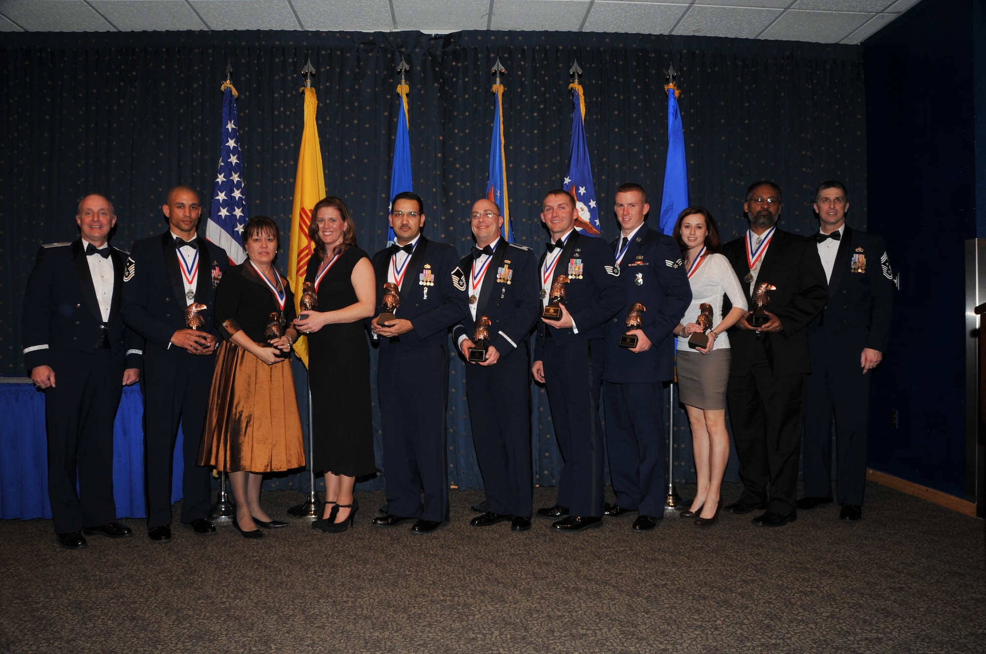 Air Force Nuclear Weapons Center annual award winners with Brig. Gen. Garrett Harencak, Air Force Nuclear Weapons Center commander are Master Sgt. William Moore, First Sergeant of the Year, Lisa Esparza, Civilian of the Year Category IV, Crystal Franco, Civilian of the Year Category II, Master Sgt. Anthony Khan, Senior NCO of the Year, Capt. Claus Fasting, Company Grade Officer of the Year, Staff Sgt. Jordan Bishopp, NCO of the Year, Senior Airman Joseph Crotty, Airman of the Year, Leighanna Martinez, Civilian of the Year Category I, Terry Turner, Civilian of the Year Category III and Chief Master Sgt. Eric Jaren, Air Force Materiel Command command chief.  U.S. Air Force Photo by Todd Berenger