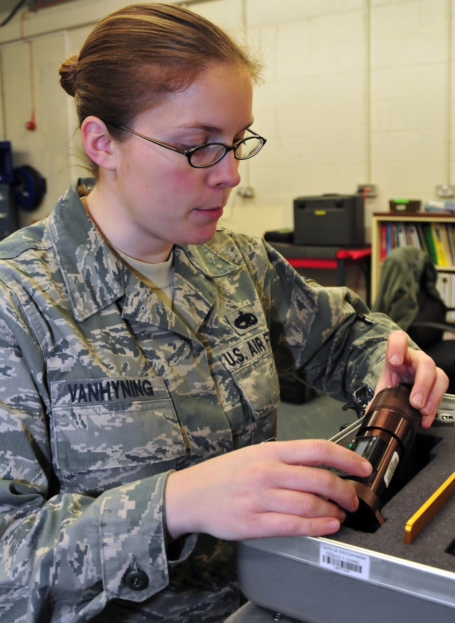ROYAL AIR FORCE LAKENHEATH, England -- Tech. Sgt. Catherine A. VanHyning, 48th Equipment Maintenance Squadron Aircraft Structural Maintenance Support Section NCO in charge inspects an optical micrometer for any discrepancies Feb. 25. Sergeant VanHyning was selected as the 48th Fighter Wing's Liberty Spotlight due to her portrayal of the core value of 'Service Before Self'. (U.S. Air Force photo/ Staff Sgt. Megan P. Lyon)