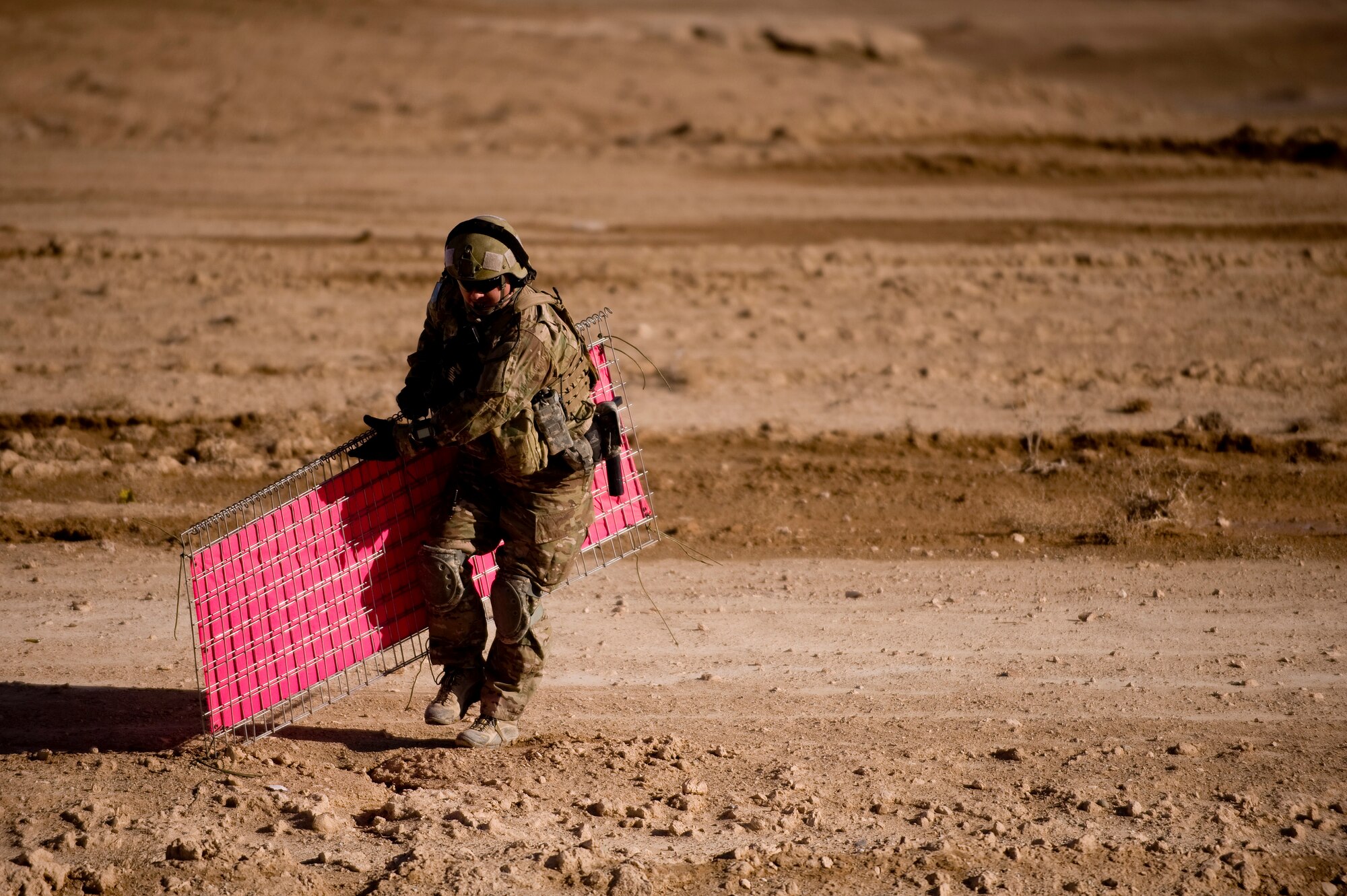Tech. Sgt. Jason Rutledge a Joint Terminal Air Controller, 807th Expeditionary Air Support Operations Squadron, Forward Operating Base Lagman deployed from1st Air Support Operations Squadron, Weisbaden, Germany, tears down airfield panels on a dirt landing zone in the Zabul Province of Afghanistan. The panels were set up to indicate a C-130 Hercules aircrew where they should land. Sergeant Rutledge was there to make sure the dirt landing zone was safe for a cargo carrying C-130 Hercules to land and provide the aircrew with any pertinent information via radio communications. The aircrew was delivering needed cargo for one of the nearby military outposts. (U.S. Air Force Photo/ Master Sgt. Adrian Cadiz)(Released)