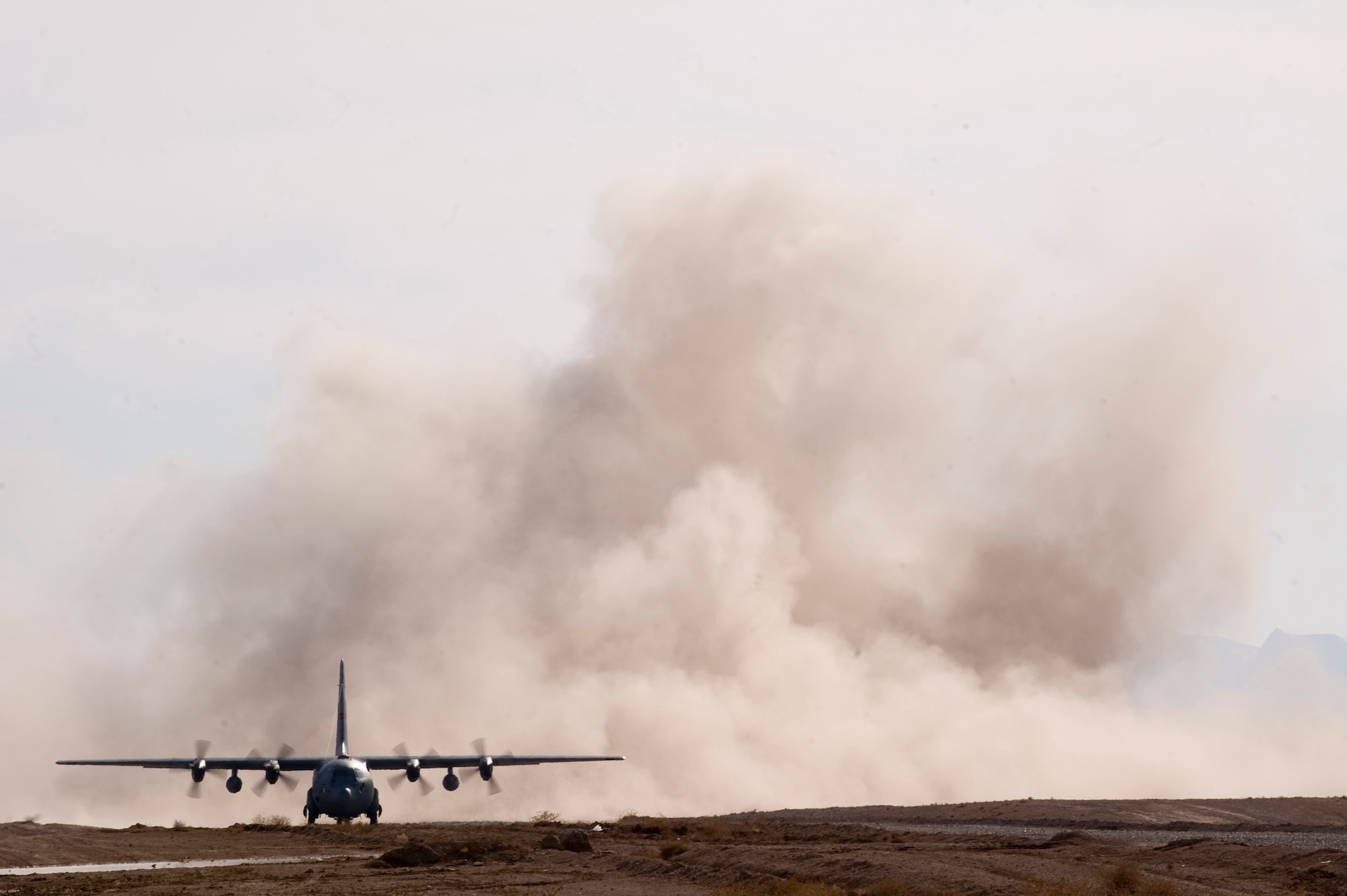 A C-130 Hercules prepares to depart a dirt landing zone in the Zabul Province of Afghanistan.Airmen from the 807th Expeditionary Air Support Operations Squadron, Forward Operating Base Lagman, made sure the dirt landing zone was safe for the cargo carrying C-130 Hercules to land and depart and provided the aircrew with any pertinent information via radio communications. The aircrew was delivering needed cargo for one of the nearby military outposts. (U.S. Air Force Photo/ Master Sgt. Adrian Cadiz)(Released)