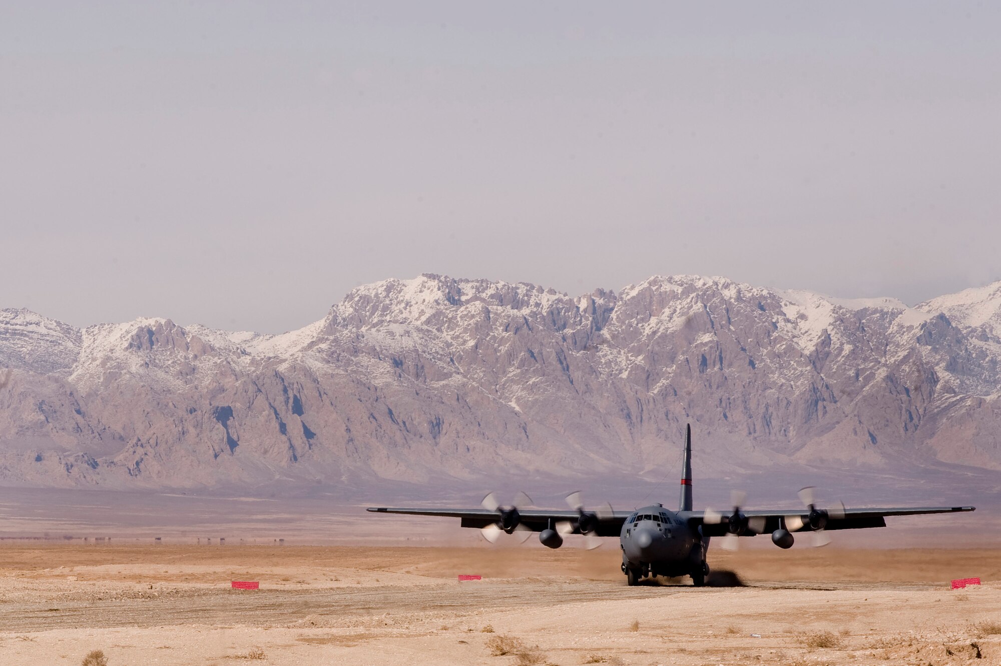 A C-130 Hercules prepares lands on a dirt landing zone in the Zabul Province of Afghanistan. Airmen from the 807th Expeditionary Air Support Operations Squadron, Forward Operating Base Lagman, made sure the dirt landing zone was safe for the cargo carrying C-130 Hercules to land and provided the aircrew with any pertinent information via radio communications. The aircrew was delivering needed cargo for one of the nearby military outposts. (U.S. Air Force Photo/ Master Sgt. Adrian Cadiz)(Released)