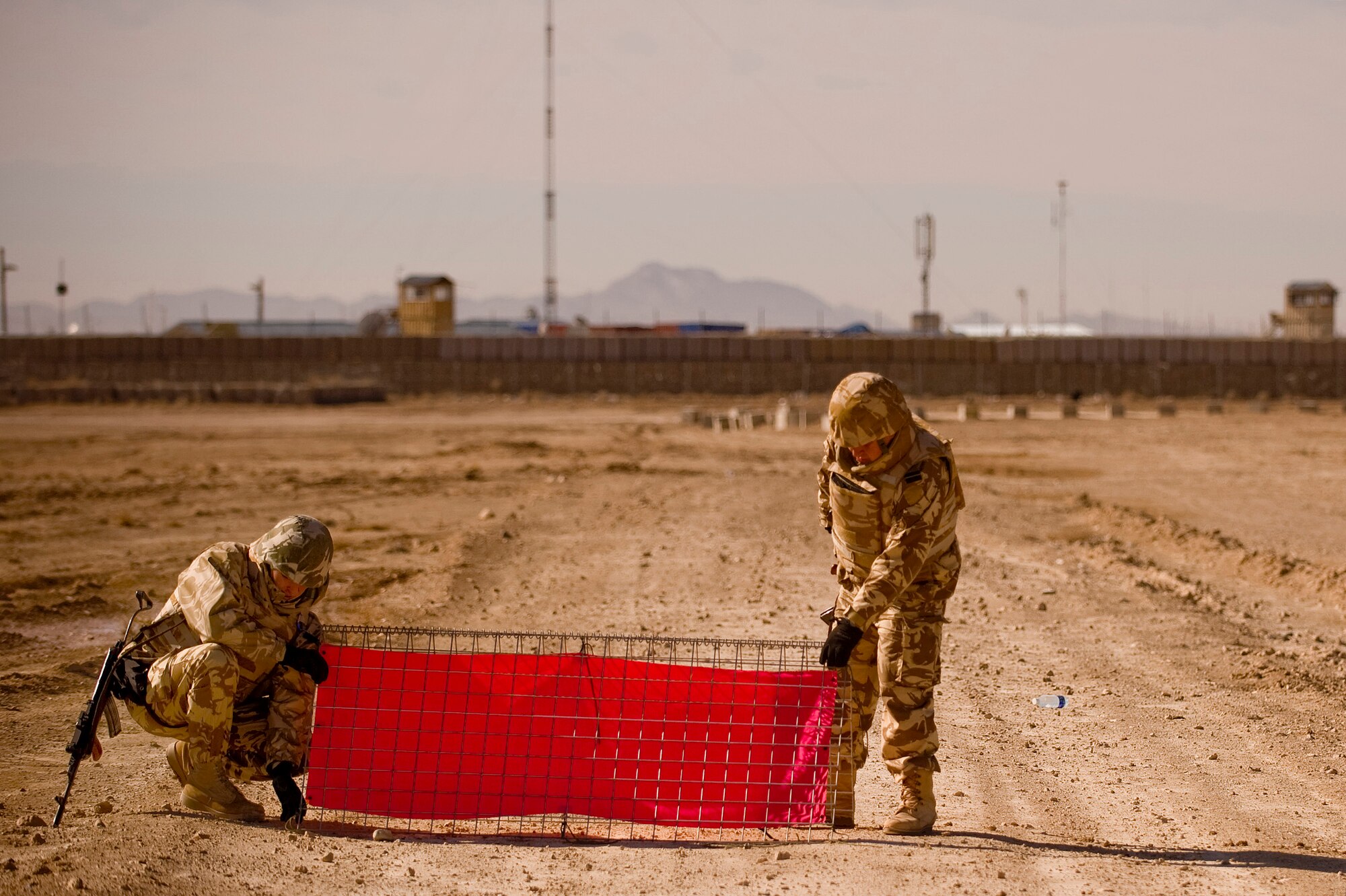 Romanian Army Soldiers from Forward Operating Base Lagman, Afghanistan learn how to set up airfield panels during the hands on  portion of a Landing Zone Safety Officer (LZSO) class. Students were in the class to be certified to safely run the dirt landing and drop zone in the Zabul Province near FOB Lagman. The class was made up of U.S. Air Force, Army, and Romanian Army personnel and was taught by U.S. Air Force instructors from Combined Joint Task Force 101, Headquarters Air Mobility Liaison Office. (U.S. Air Force Photo/ Master Sgt. Adrian Cadiz)(Released)
