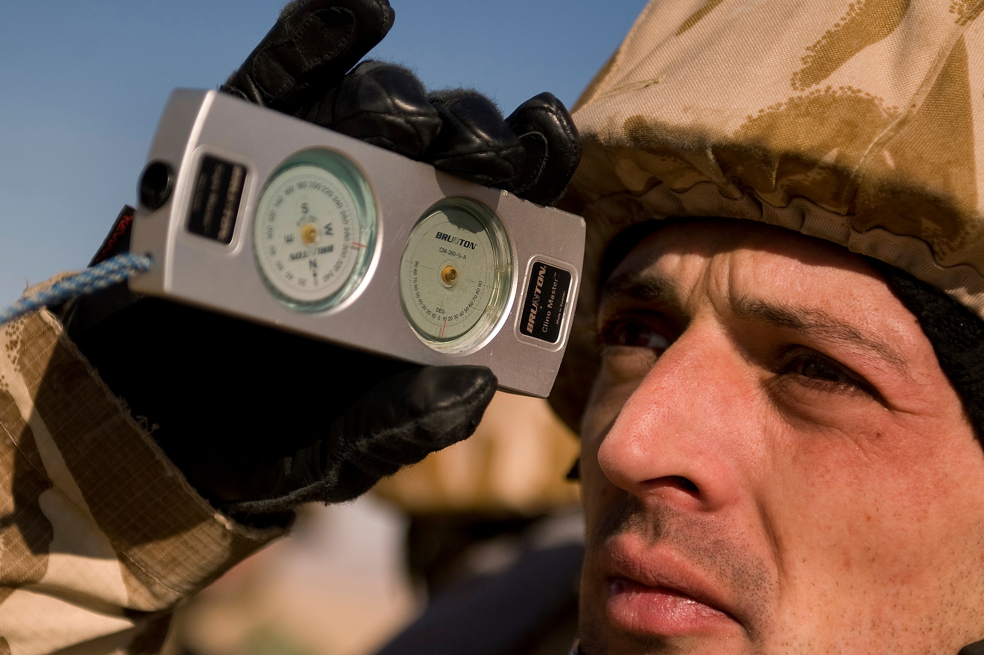 A Romanian army soldier learns how to use a clinometer to take a glide path reading during a  Landing Zone Safety Officer (LZSO) class. The class consisted of U.S. Air Force, Army, and Romanian Army personnel from Forward Operating Base Lagman, Afghanistan and was taught by  U.S. Air Force instructors from Combined Joint Task Force 101, Headquarters Air Mobility Liaison Office.. Students were in the class to be certified to safely run the dirt landing and drop zone in the Zabul Province near FOB Lagman. (U.S. Air Force Photo/ Master Sgt. Adrian Cadiz)(Released)