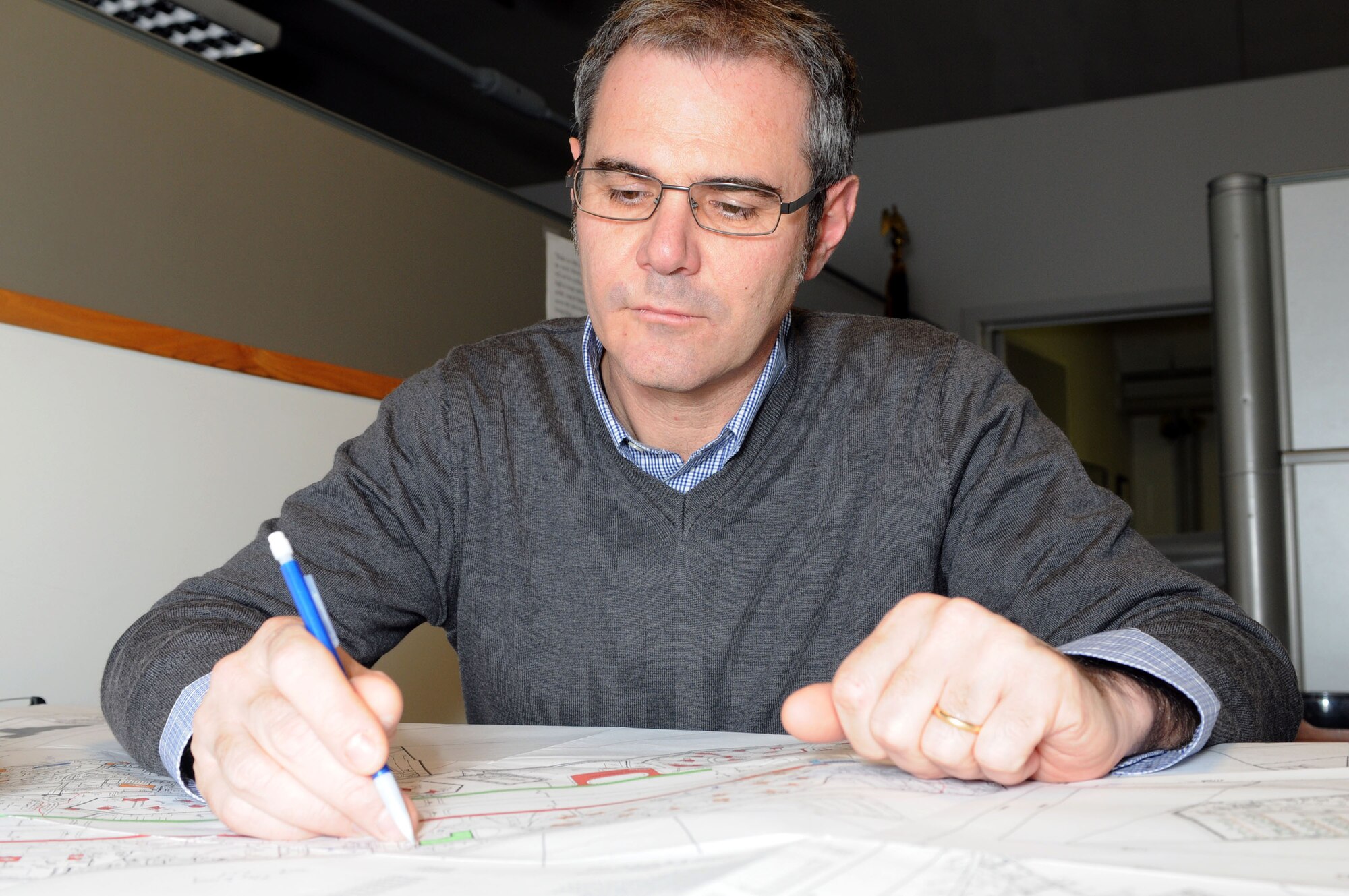 Damiano Rigo, 31st Civil Engineer Squadron asset optimization element chief, marks a base plan Feb. 23. Mr. Rigo recently received the 2010 U.S. Air Forces in Europe Civil Engineer General Thomas D. White Sustainability award. (U.S. Air Force photo/Staff Sgt. Julius Delos Reyes)