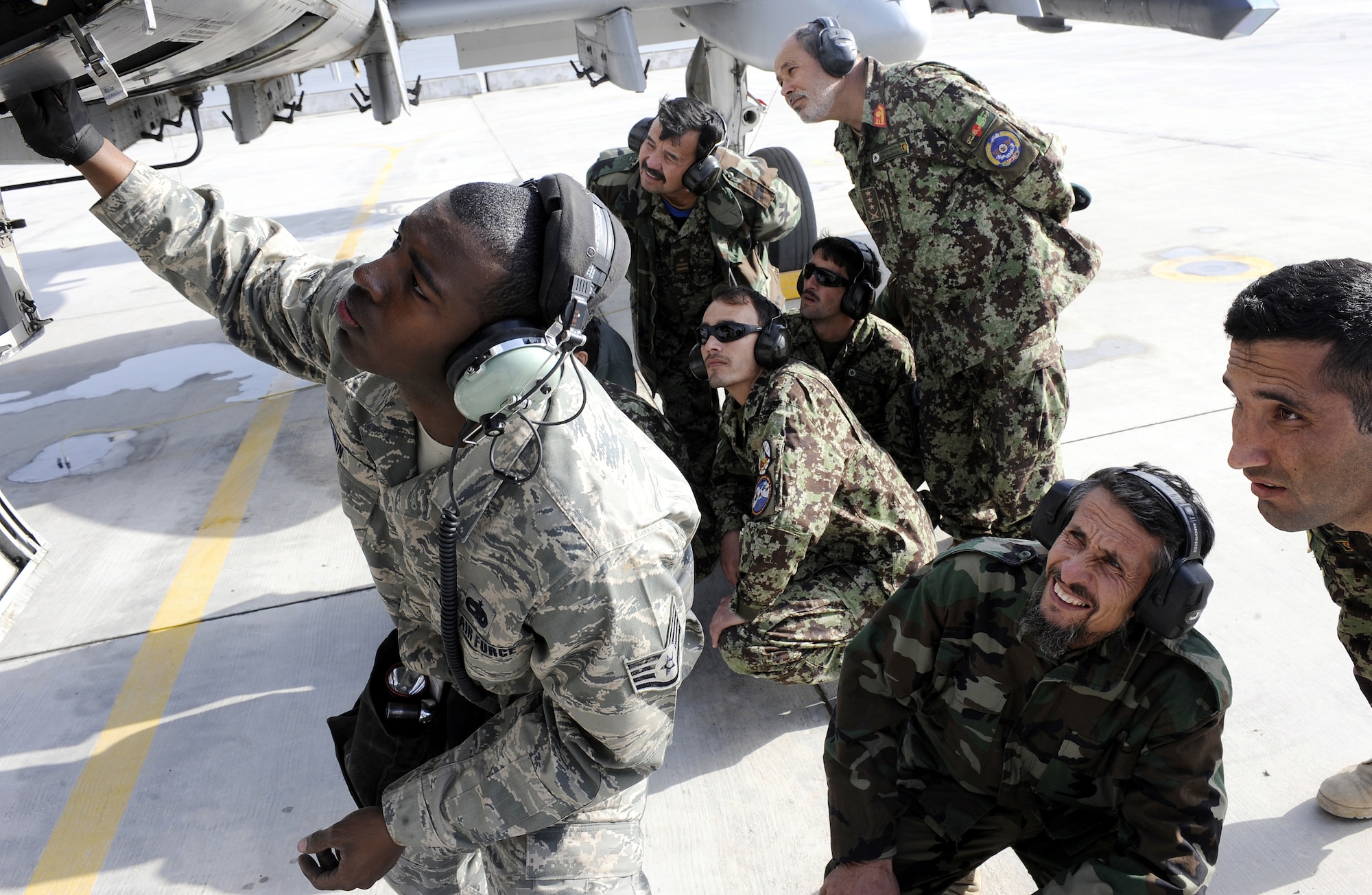 Staff Sgt. Harrison Ragin positions the ammo in an A-10C Thunderbolt II during a demonstration for the Afghan air force, Feb. 22, 2011, at Kandahar Airfield, Afghanistan. The munitions demonstration was organized to show the efficiency and safety that has helped make the U.S. Air Force successful. Sgt. Ragin is a load crew chief assigned to the 451st Expeditionary Aircraft Maintenance Squadron. (U.S. Air Force photo/Senior Airman Willard E. Grande II/Released)
