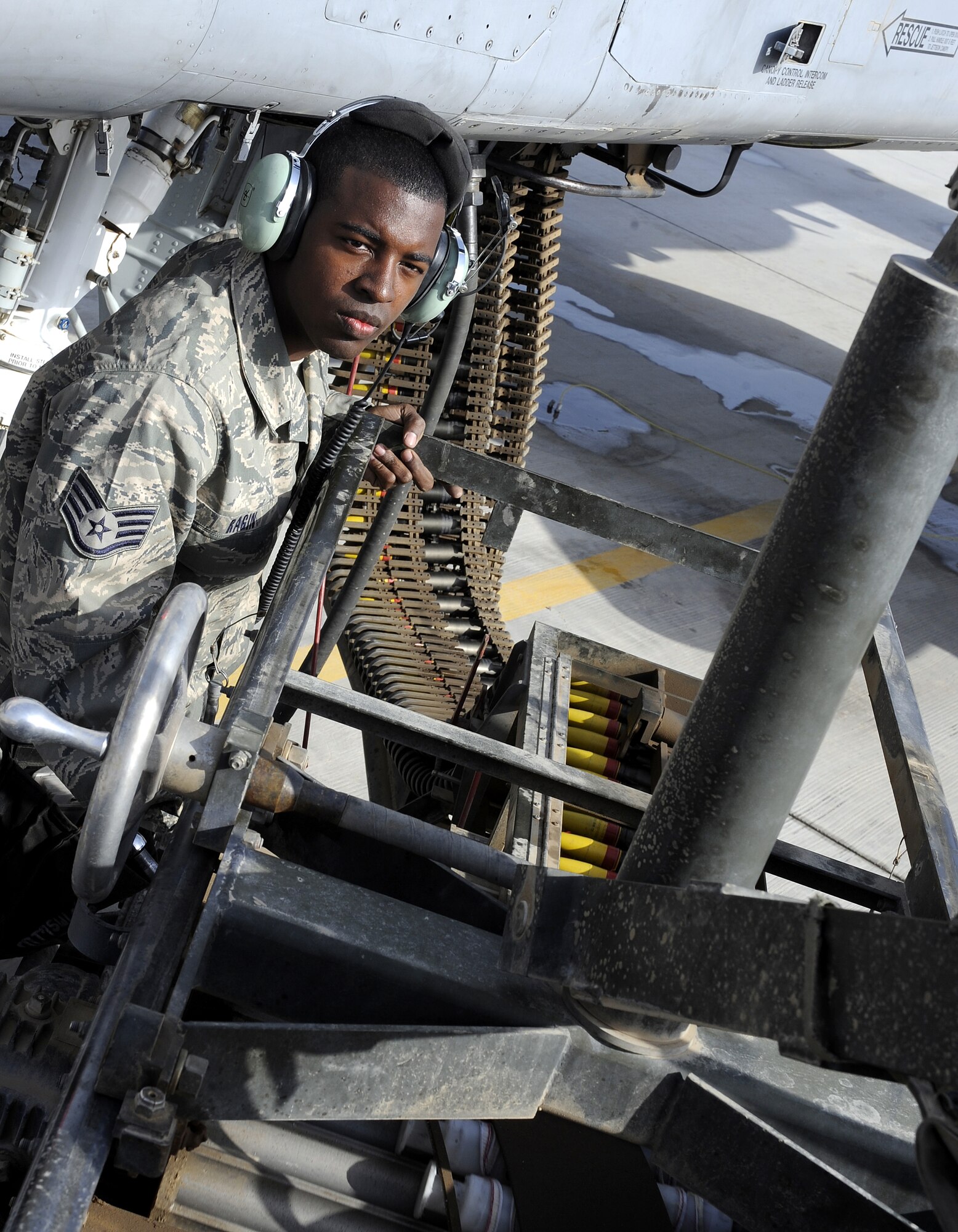 Staff Sgt. Harrison Ragin loads an A-10C Thunderbolt II with 30 mm high explosive incendiary rounds during a demonstration for Afghanistan's Kandahar Air Wing, Feb. 22, 2011, at Kandahar Airfield, Afghanistan. The demonstration will help instill a culture of safety, respect for the power of the machinery and its risks to the new Afghan military. Sgt. Ragin is a load crew chief assigned to the 451st Expeditionary Aircraft Maintenance Squadron. (U.S. Air Force photo/Senior Airman Willard E. Grande II/Released)