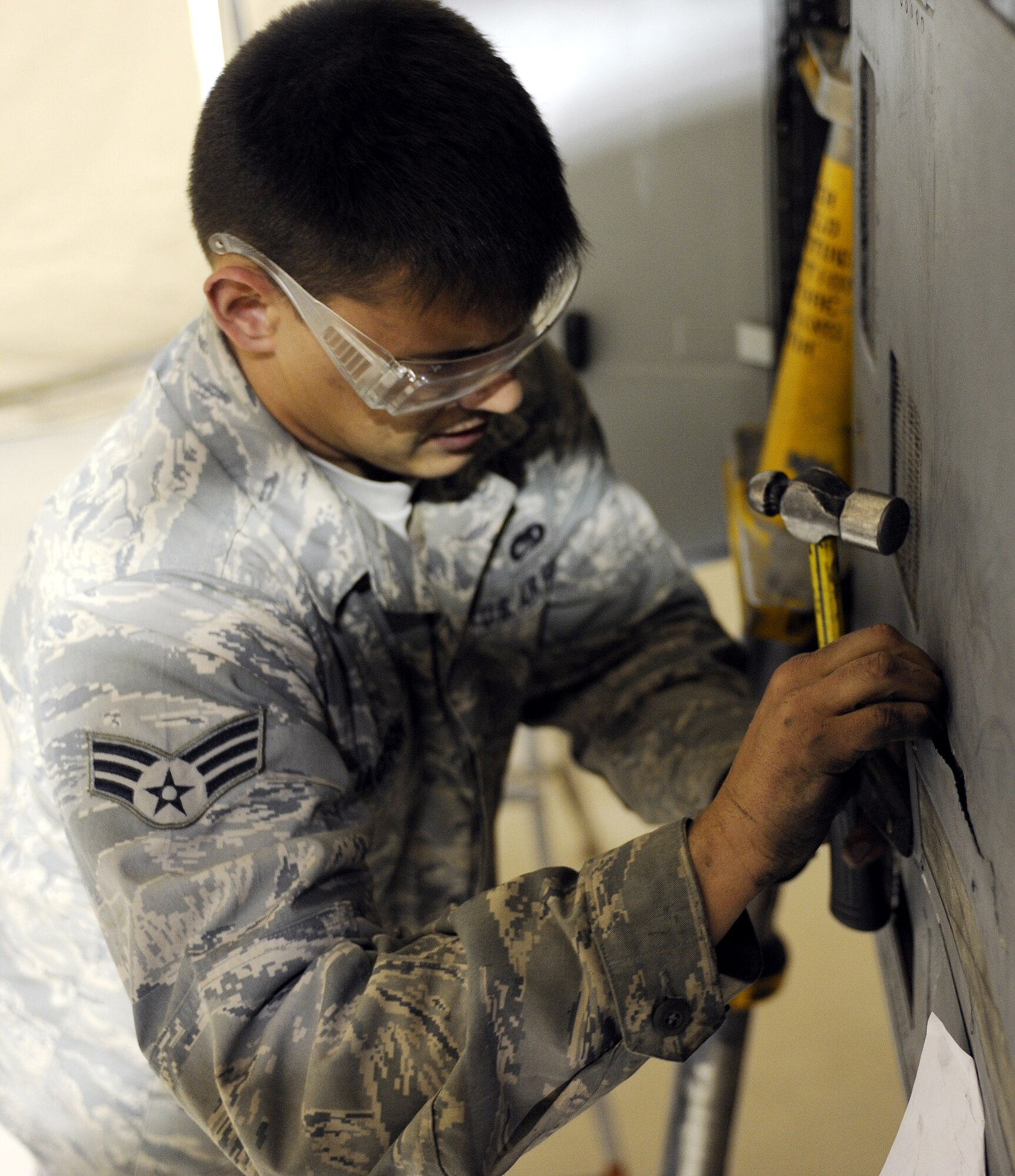 Senior Airman Jamie Jackson removes a formation light from an A-10C Thunderbolt II during a phase inspection, Feb. 22, 2011, at Kandahar Airfield, Afghanistan. The 451st Expeditionary Maintenance Squadron conducts a phase inspection every 500 flight hours. Twenty inspections have been conducted in the past five months indentifying and repairing more than 6,000 total discrepancies. Airman Jackson is an aircraft structural maintenance journeyman assigned to the 451st EMXS. (U.S. Air Force photo/Senior Airman Willard E. Grande II/Released)