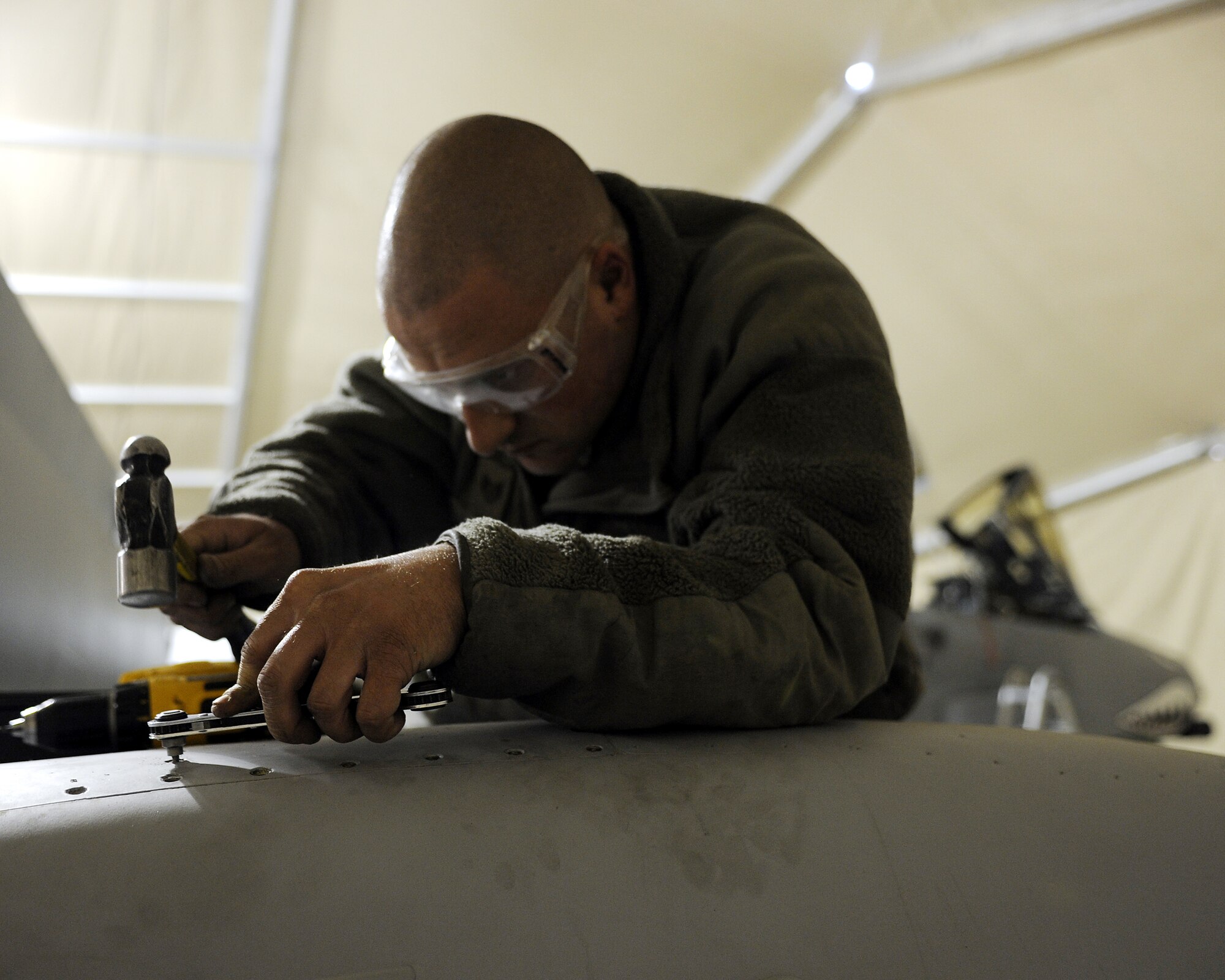 Staff Sgt Jonathan Shipp removes stuck screws from an access panel of an A-10C Thunderbolt II during a phase inspection, Feb. 22, 2011, at Kandahar Airfield, Afghanistan. The 451st Air Expeditionary Wing?s Expeditionary Maintenance Squadron conducts a phase inspection every 500 flight hours. The specific needs of the aircraft, any discrepancies, merit the attention of the subject matter experts who specialize in their respective repairs. Sergeant Shipp is an aircraft structural maintenance craftsman assigned to the 451st EMXS. (U.S. Air Force photo/Senior Airman Willard E. Grande II/Released)