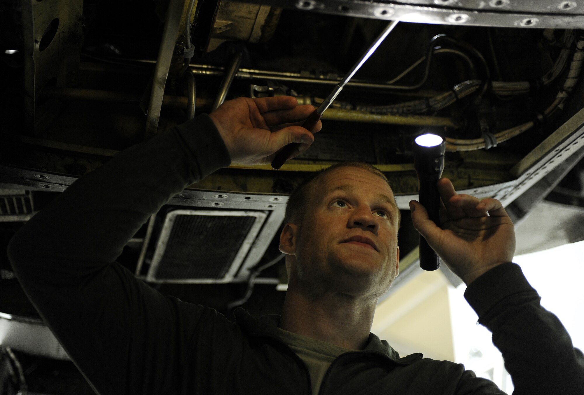 Senior Airman Austin Strabala inspects the environmental control system compartment for foreign objects prior to a quality assurance inspection, Feb. 22, 2011, at Kandahar Airfield, Afghanistan. During the inspection, airmen might find hairline cracks, missing bolts, worn wires or hydraulic lines. Airman Strabala is an A-10 phase inspection section journeyman assigned to the 451st Expeditionary Maintenance Squadron. (U.S. Air Force photo/Senior Airman Willard E. Grande II/Released)