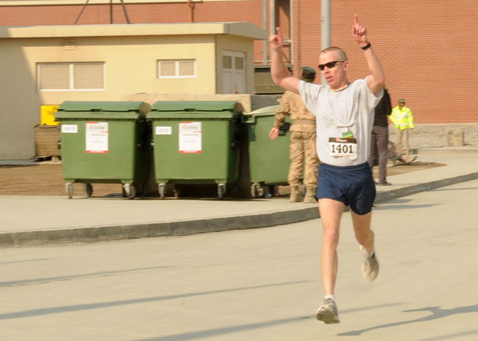 KABUL, Afghanistan - Maj. James Boddy, race coordinator and participant of the annual Fort Worth Cowtown race, one of the largest multi-event road races in the United States, takes first place with a time of 1:21:36 at the Kabul International Airport, Afghanistan Feb 25. (U.S. Navy photo by Mass Communications Specialist 3rd Class Jared E. Walker).