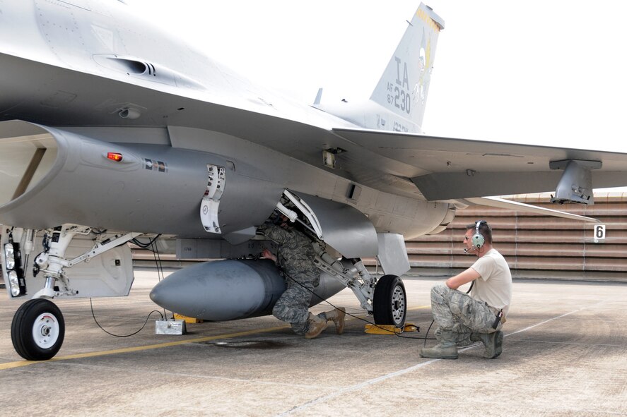 Staff Sgt. Rachel Albee (left), from the 132nd Fighter Wing (132FW), Des Moines, Iowa Security Forces squadron, under the watchful eye of Master Sgt. Matthew Hand (right), Crew Chief for the 132FW, in conducting final aircraft checks on an F-16 C+ aircraft before it launches from the hardened parking revetment of the Royal Australian Air Force (RAAF), Williamtown, Australia on February 24, 2011.  Sgt. Albee is participating in the technician swap that the 132FW Maintenance Group is conducting for the 132FW and RAAF members during joint flying mission, "Sentry Down Under".  (US Air Force photo/Staff Sgt. Linda E. Kephart)(Released)