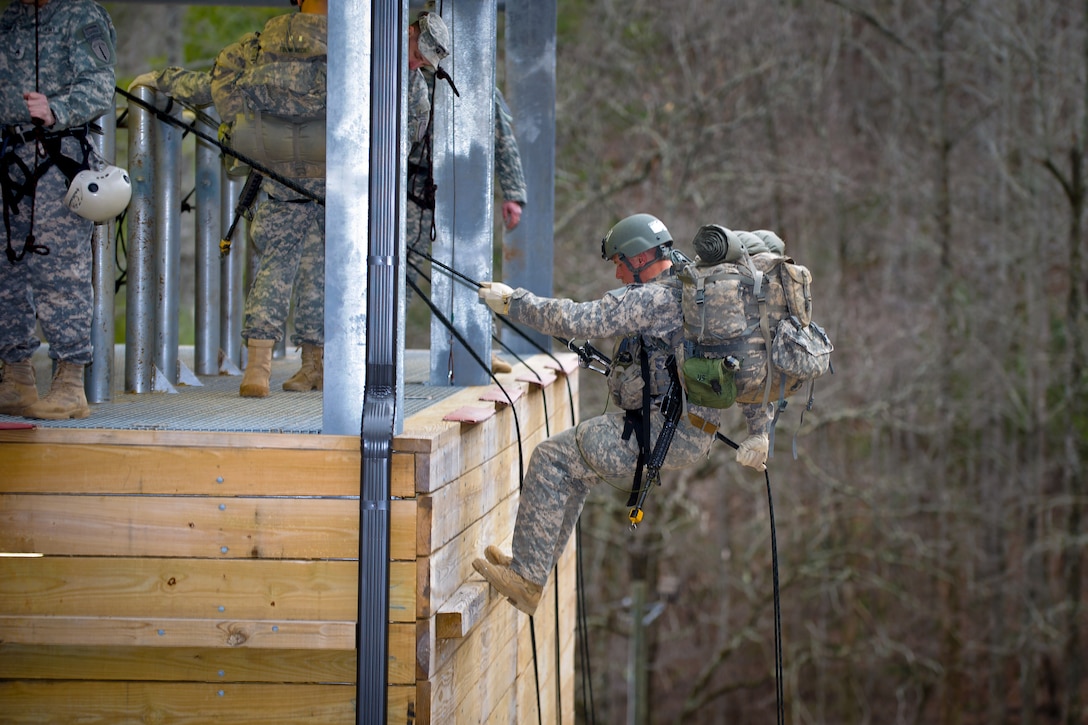 An Army Ranger prepares to rappel down the side of a 30-foot tower on Camp Frank D. Merrill, in Dahlonega, Ga., Feb. 20, 2011.
