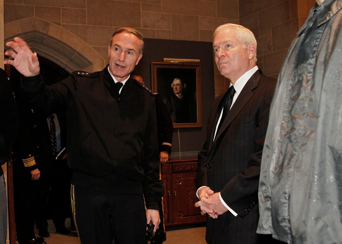 U.S. Army Lt. Gen. David H. Huntoon Jr., West Point's 57th superintendent, explains the mural in the Cadet Mess Hall to Defense Secretary Robert M. Gates during his visit to the U.S. Military Academy, West Point, N.Y., Feb. 25, 2011. 