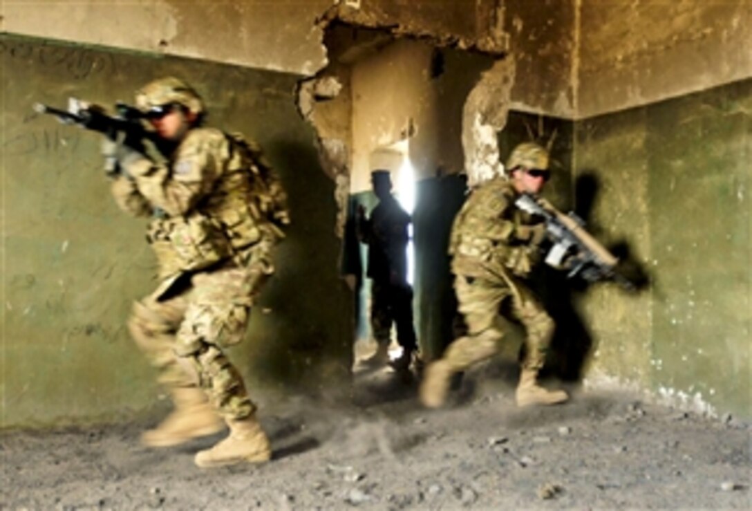 U.S. Army soldiers serving as mentors for Afghan soldiers demonstrate how to secure a room during urban terrain training at Camp Zafar in Afghanistan's Herat province on Feb. 21, 2011.  The training provides recruits with a basic understanding of urban combat techniques during their basic warrior course.  