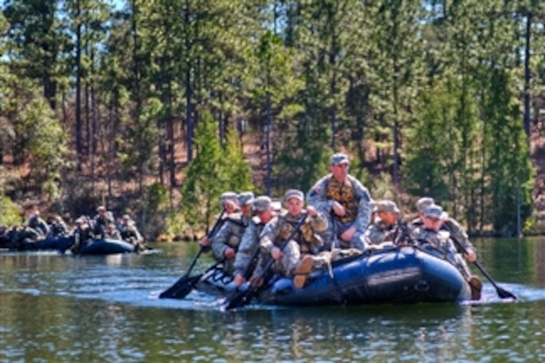 U.S. Army Ranger students paddle in rubber boats across a lake during the swamp training phase at Camp Rudder on Eglin Air Force Base, Fla., on Feb. 15, 2011.  
