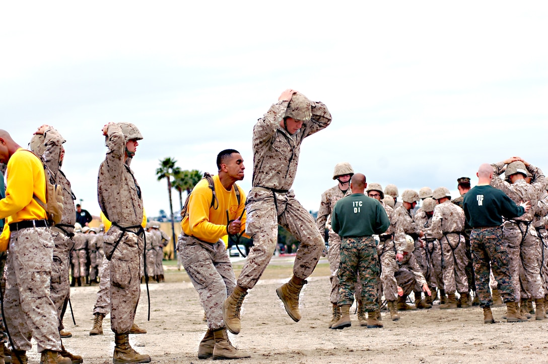 Sgt. Beltran Jordan, drill instructor, platoon 2169, Company H, ensures that recruits’ harnesses are tight enough to ensure their safety. The rope must support the recruit’s entire weight during descent from the rappel tower.