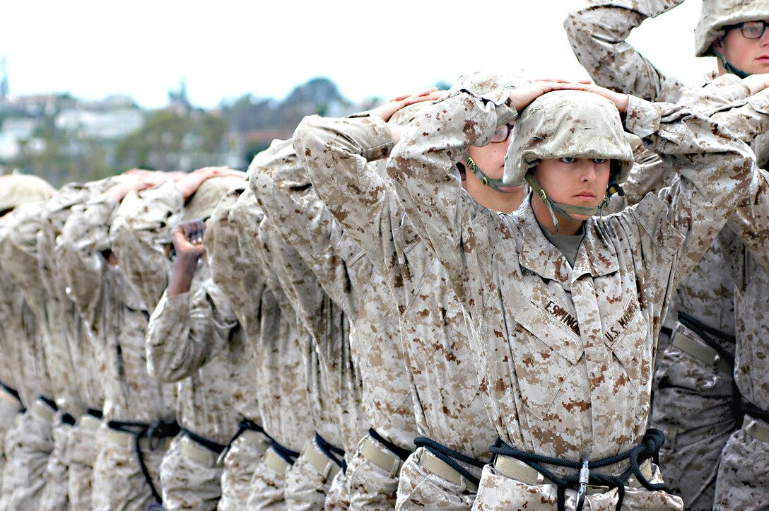 Recruit Mark Espinoza, platoon 2169, Company H, walks his eyes up the 100 feet of stairs that lead to the rappel platform above. Recruits complete the rappel tower to give essential training, as well as to give the recruits confidence in the gear and themselves.