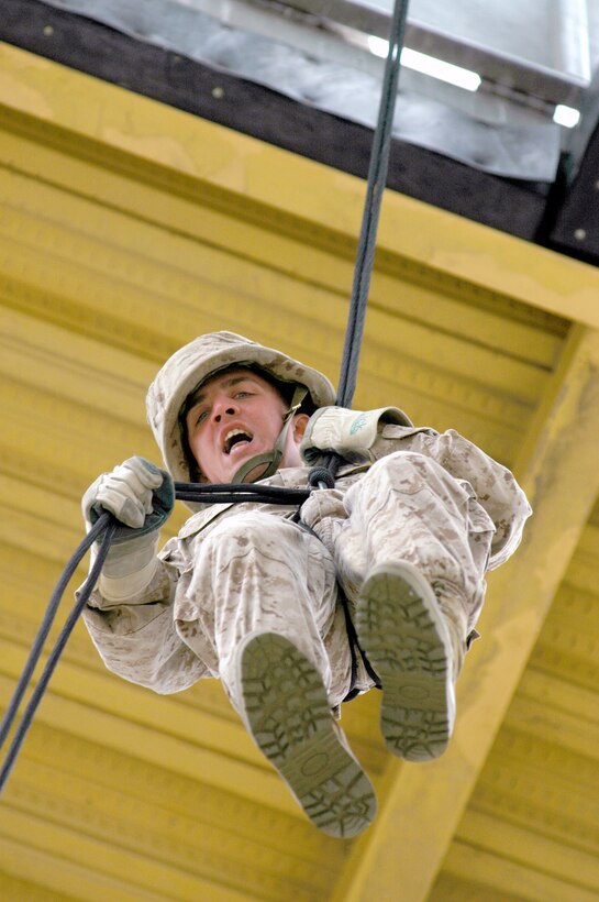 Recruit Nickolas Mandich, platoon 2171, fast ropes through the rappel platform as a part of the confidence course. The fast rope gap, or hell hole, is designed to simulate disembarking from a helicopter.