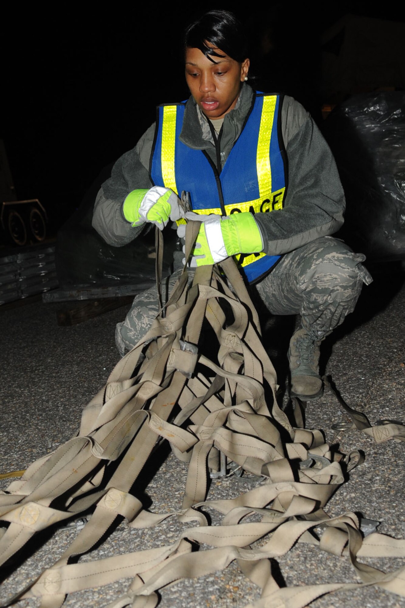 Staff Sgt. Whitney Boyd, 633d Logistics Readiness Squadron aircraft part store technician, unravels cargo netting during an Operation Readiness Exercise at Langley Air Force Base, Va., Feb. 26, 2011.  Wing exercise evaluation team members assessed the 1st Fighter Wing, 633d Air Base Wing, and 192d Fighter Wing's readiness to deploy during a two-day time period. (U.S. Air Force photo by Staff Sgt. Ashley Hawkins/Released)