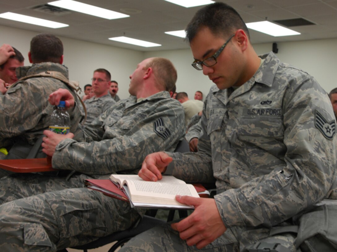 Staff Sgt. David Guba, 1st Maintenance Squadron non-destructive inspection craftsman, reads while processing through a personnel deployment function line at Langley Air Force Base, Va., Feb. 26, 2011. The PDF line was part of a two-day Operational Readiness Exercise in which the 633d Air Base Wing, 1st Fighter Wing and 192d Fighter Wing worked together to test their ability to deploy Airmen, aircraft and cargo on short notice. (U.S. Air Force photo by Airman 1st Class Camilla Elizeu/Released)  