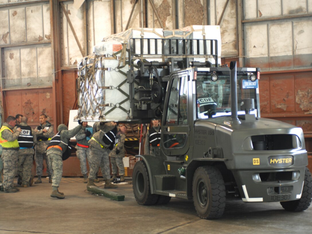 Airmen inspect cargo pallets for cracks or broken straps during an Operational Readiness Exercise at Langley Air Force Base, Va., Feb. 26, 2011. Personnel from the 633d Air Base Wing, 1st Fighter Wing and 192d Fighter Wing participated in the two-day exercise, designed to gauge the wing's ability to deploy cargo, aircraft and Airmen within a limited timeframe. (U.S. Air Force photo by Airman 1st Class Teresa Zimmerman/Released)