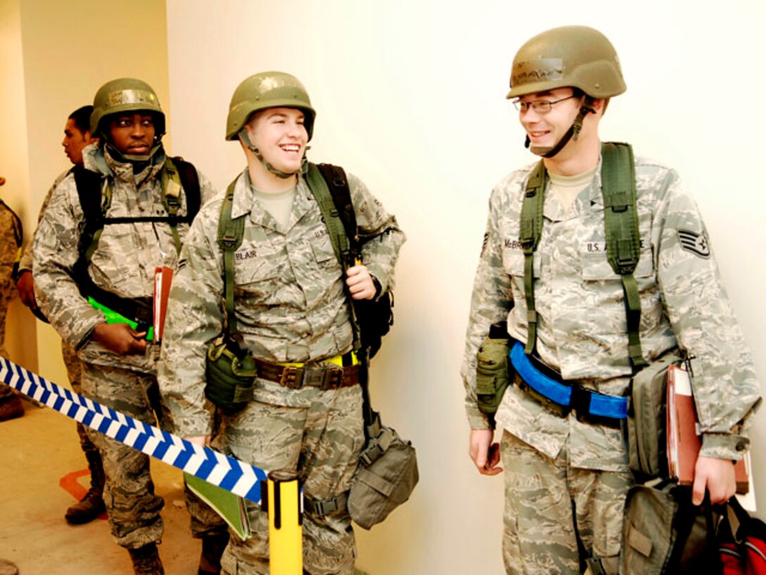 Staff Sgt. Ephraim Stacy, Airman 1st Class Matthew Blair and Staff Sgt. Kenneth Mcbride process through the personnel deployment function line during an Operational Readiness Exercise at Langley Air Force Base, Va., Feb. 26, 2011. The 633d Air Base Wing, 1st Fighter Wing and 192d Fighter Wing participated in the two-day exercise to test their ability to deploy Airmen, aircraft and cargo on short notice.  (U.S. Air Force photo by Airman 1st Class Kayla Newman/Released)