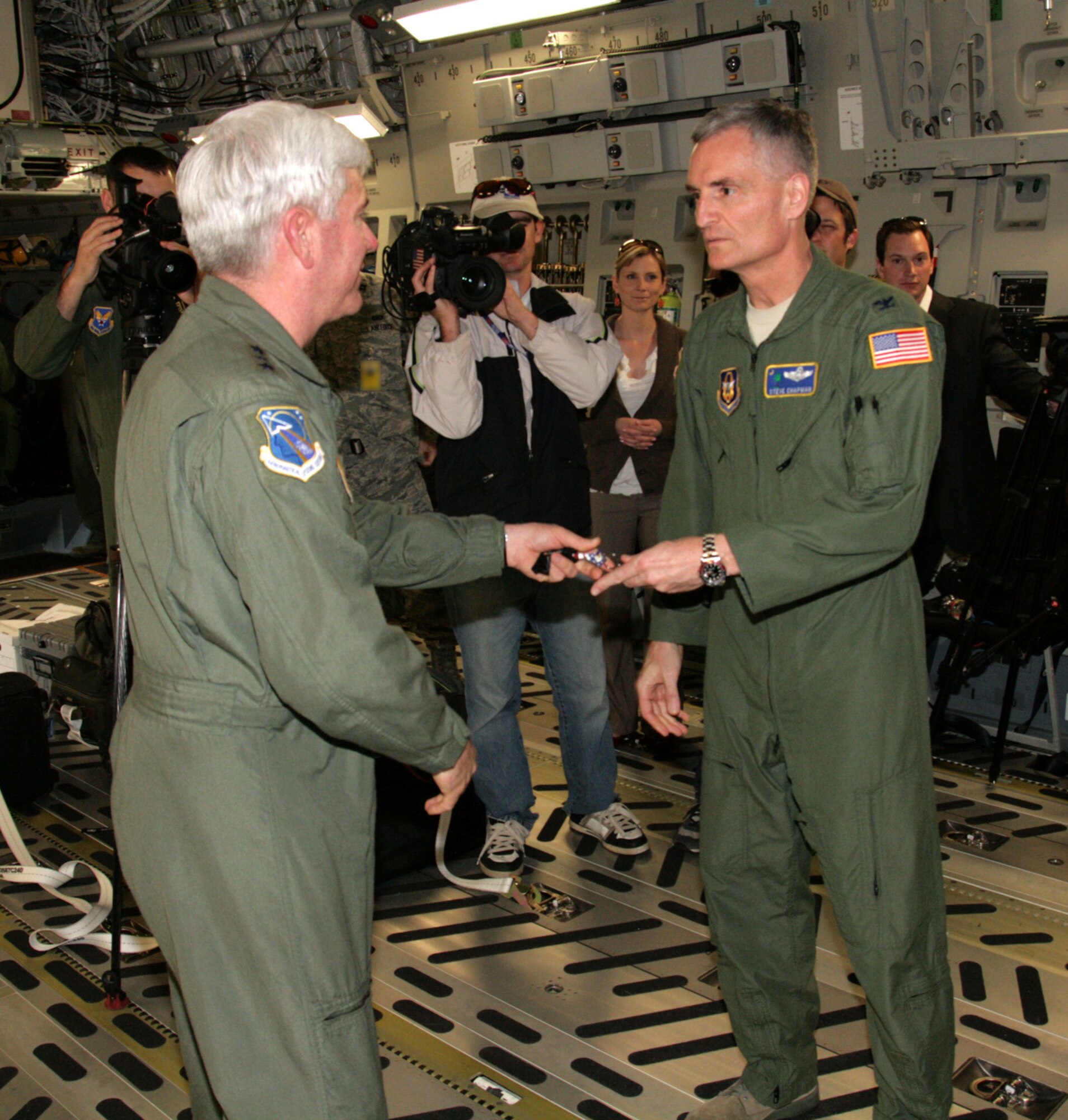 Lt. Gen. Thomas Owen, commander Air Force Aeronautical Systems Center, hands 315th Airlift Wing Commander Col. Steven Chapman the "symbolic keys" to Joint Base Charleston's newest C-17 aircraft Feb 25. The new C-17 is the 61st to be stationed at Charleston Air Force Bae. (U.S. Air Force Photo/Michael Dukes) 
