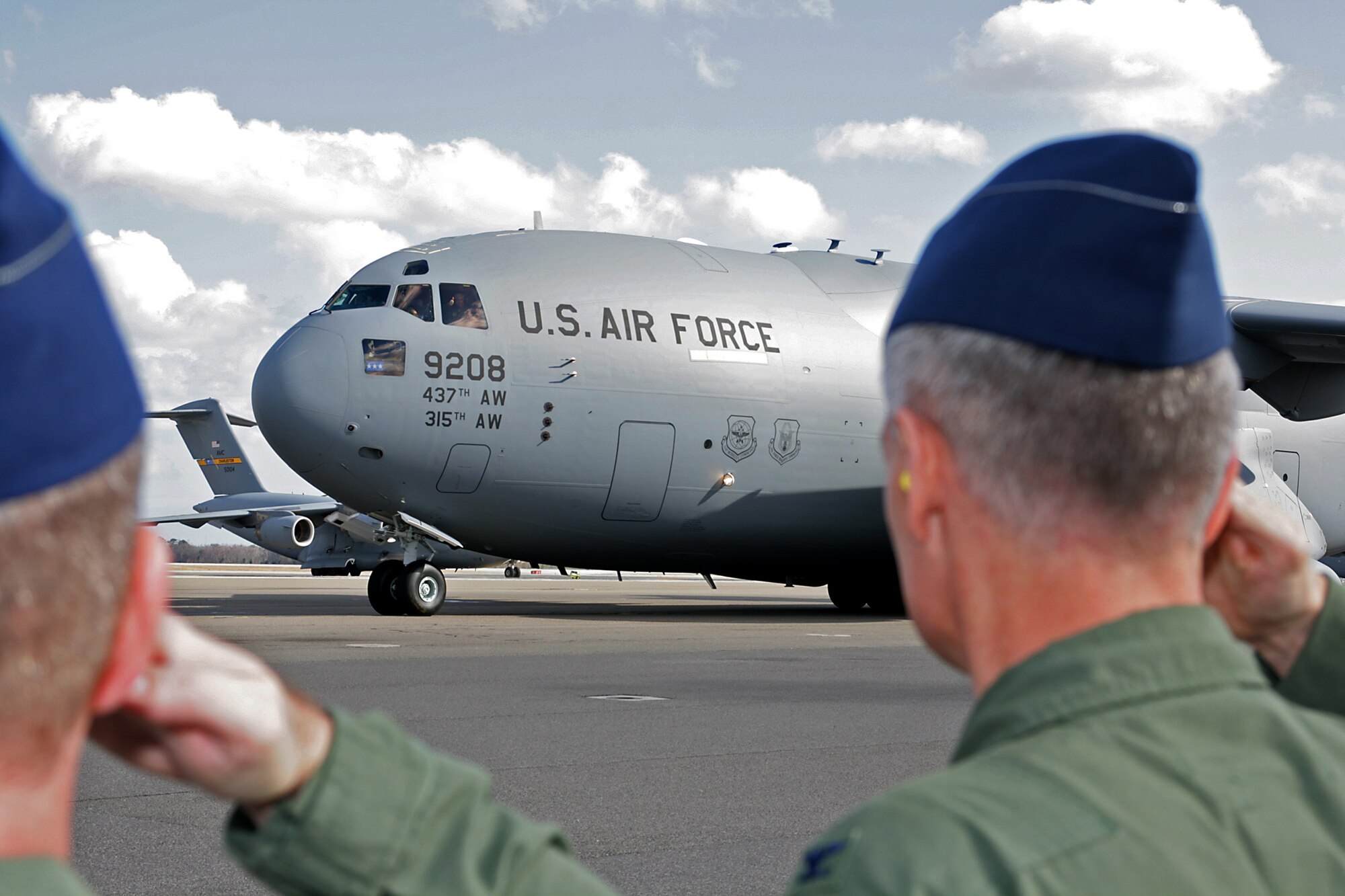 315th Airlift Wing Commander, Col. Steven Chapman and other Joint Base Charleston leadership salute the new C-17 aircraft this afternoon as it taxis on the flight line. (U.S. Air Force Photo/Michael Dukes)