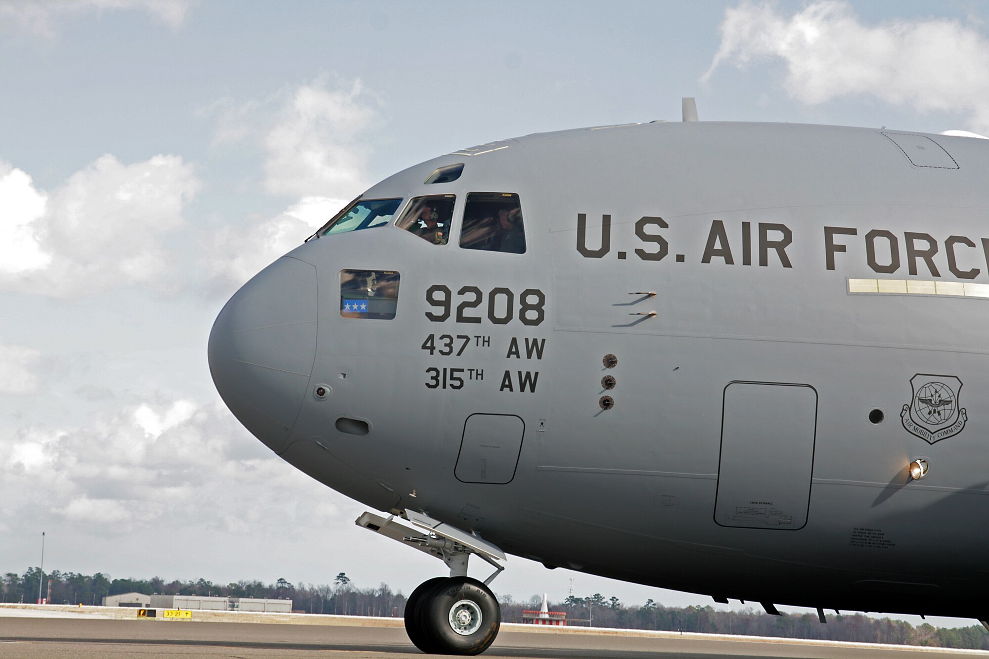 The new C-17 taxiing at Joint Base Charleston after flying from the Boeing plant in Long Beach, Calif. today. The aircraft was flown by Lt. Gen Thomas Owen commander Air Force Aeronautical Systems Center and 315th members Col. Terry Lawrence and Lt. Col John Russi. (U.S. Air Force Photo/Michael Dukes)