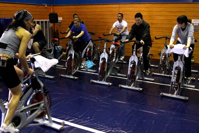 Barbara Roman, a Semper Fit fitness coordinator, leads a cycling fitness demonstration during the 2011 Marine Corps Community Services Health Expo Saturday. Many different health stations were available to the community as information was given out and questions answered about physical, financial and mental health.